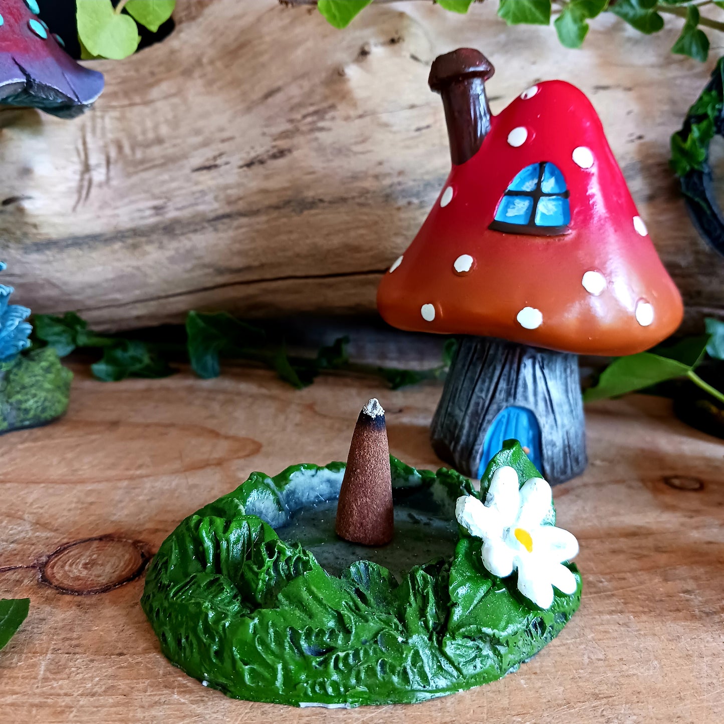 This red toadstool house design incense cone burner has wonderful detail. When the cone is burning, the smoke rises through the chimney of the item.