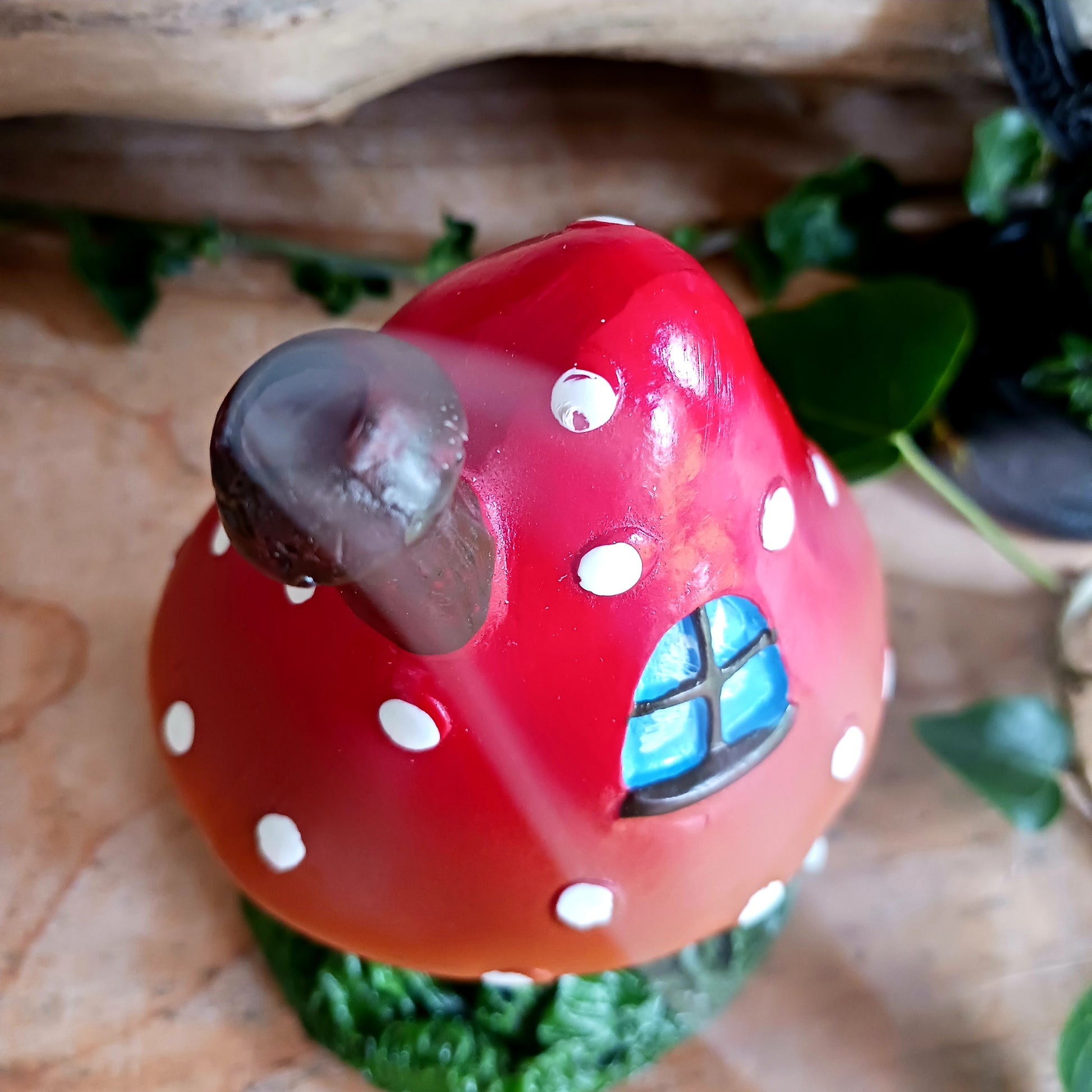 This red toadstool house design incense cone burner has wonderful detail. When the cone is burning, the smoke rises through the chimney of the item.