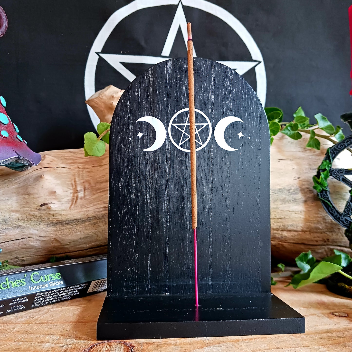 Add a touch of mystical ambiance and spiritual decor to your home with this black wooden incense shelf featuring a triple moon design, perfect for dispersing fragrance more freely.