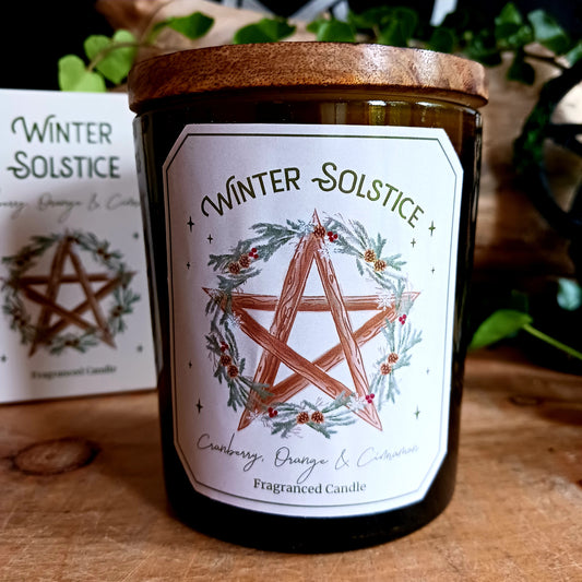 This lovely rich green glass candle with a wooden lid is fragranced with notes of Cranberry, Orange and Cinnamon and features a pretty Winter Solstic wreath and pentagram design.