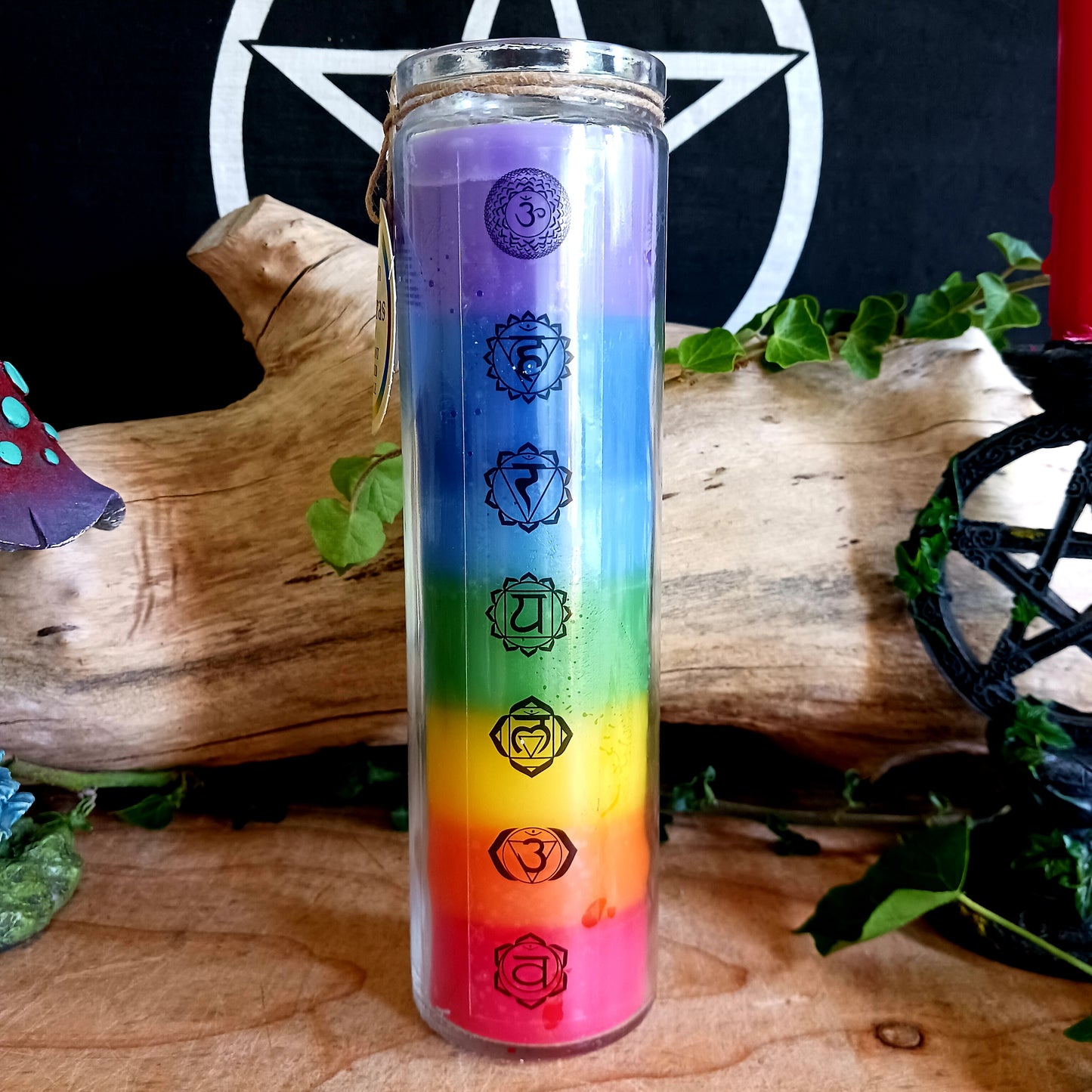 These tall tube candles have different coloured wax for each of the seven different chakras. The candle is presented in a tall glass holder with each chakra symbol over the relevant colour of wax.