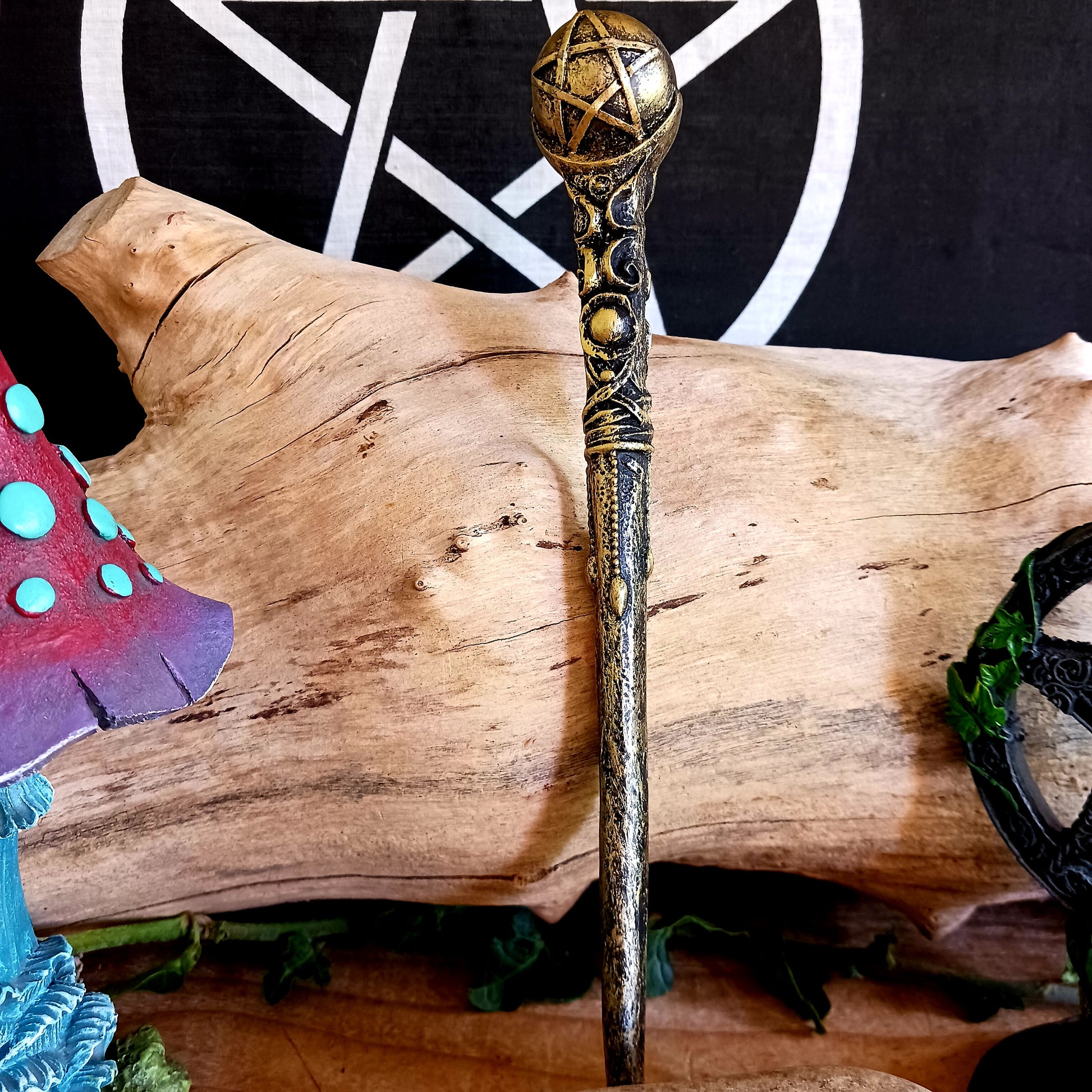 This enchanting wand features a bronze orb with pentagram symbol sitting atop an ornate and detailed wand stem. Elegant and appealing, this magic wand is a necessity for any witch or wizard's collection.