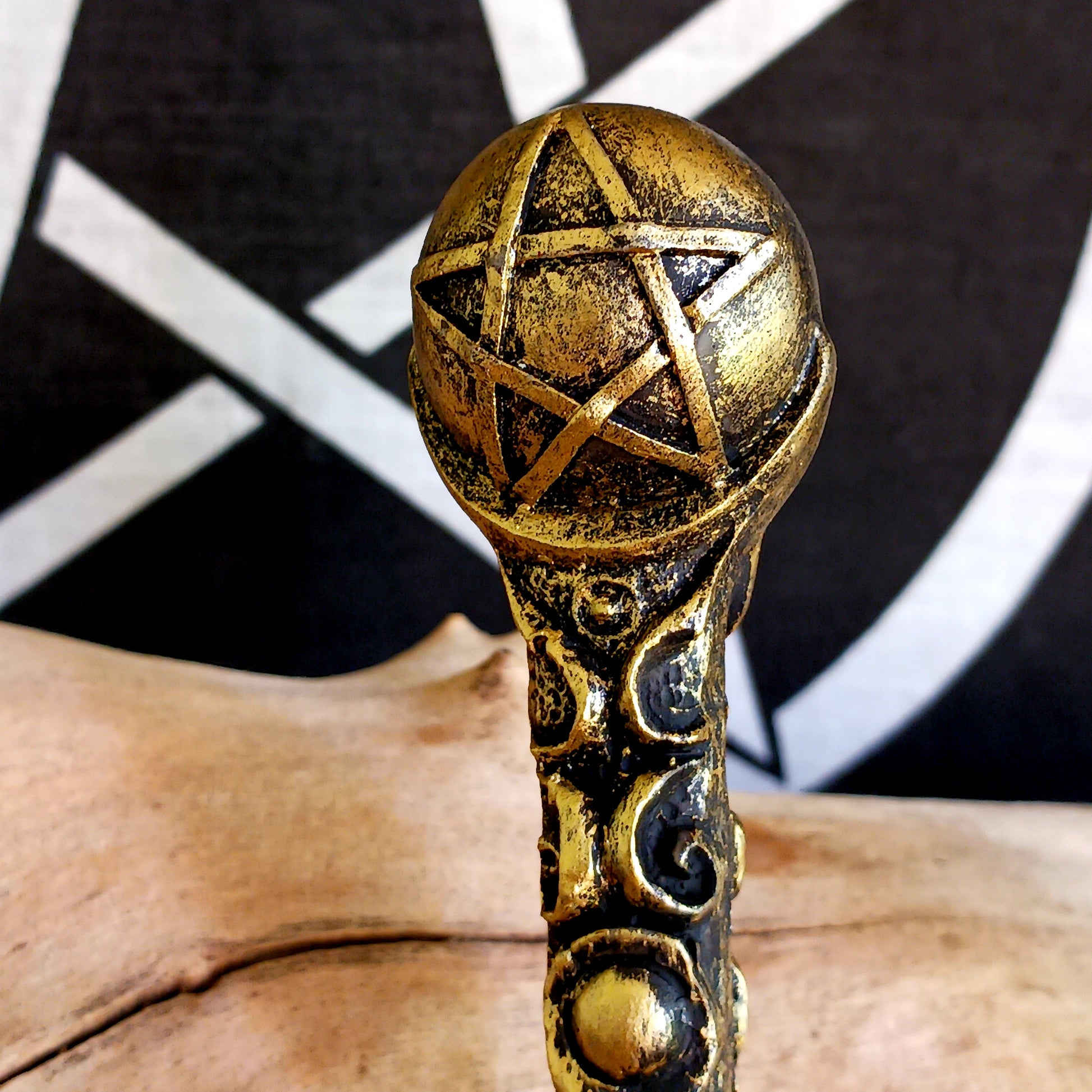 This enchanting wand features a bronze orb with pentagram symbol sitting atop an ornate and detailed wand stem. Elegant and appealing, this magic wand is a necessity for any witch or wizard's collection.