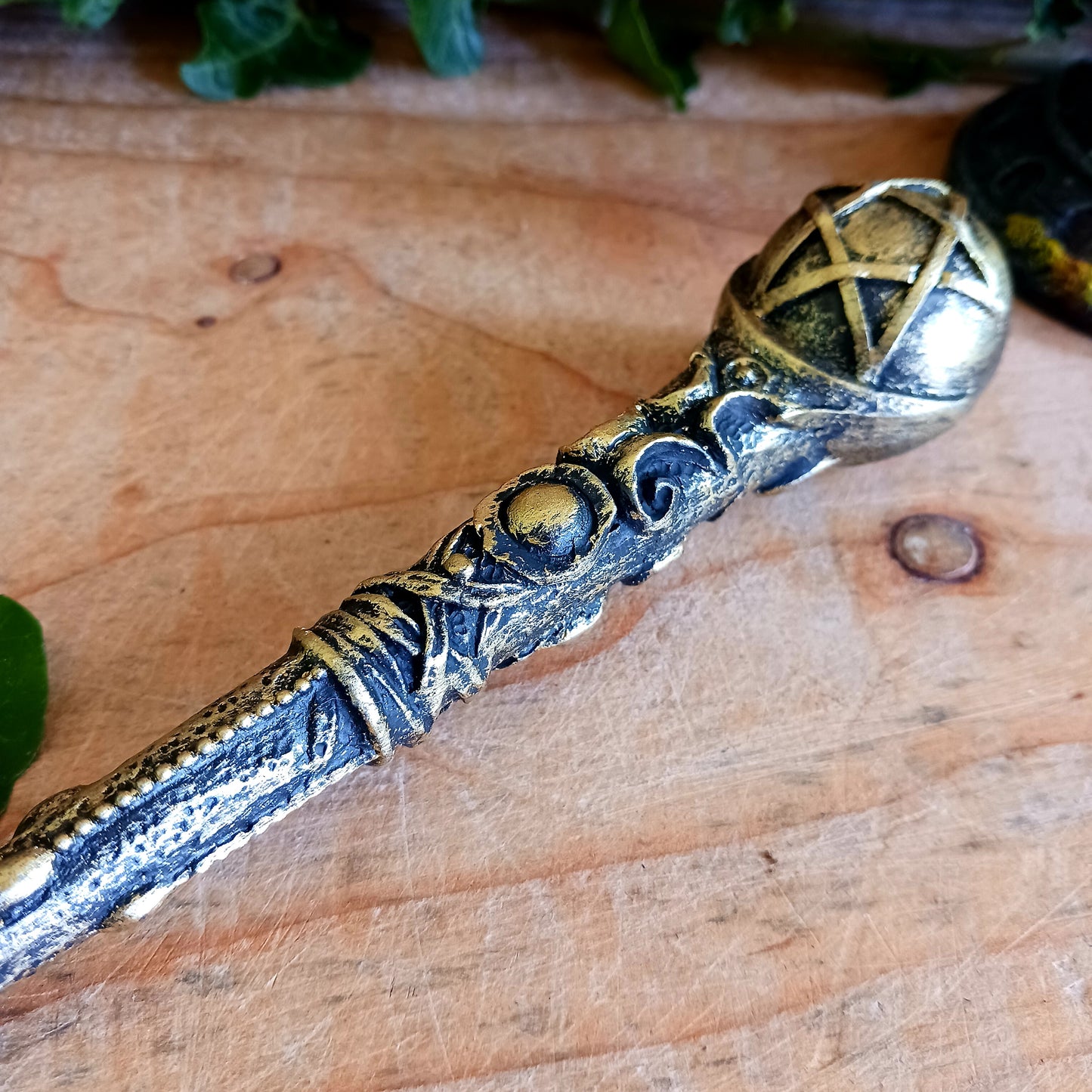 This enchanting wand features a bronze orb with pentagram symbol sitting atop an ornate and detailed wand stem. Elegant and appealing, this magic wand is a necessity for any witch or wizard's collection.