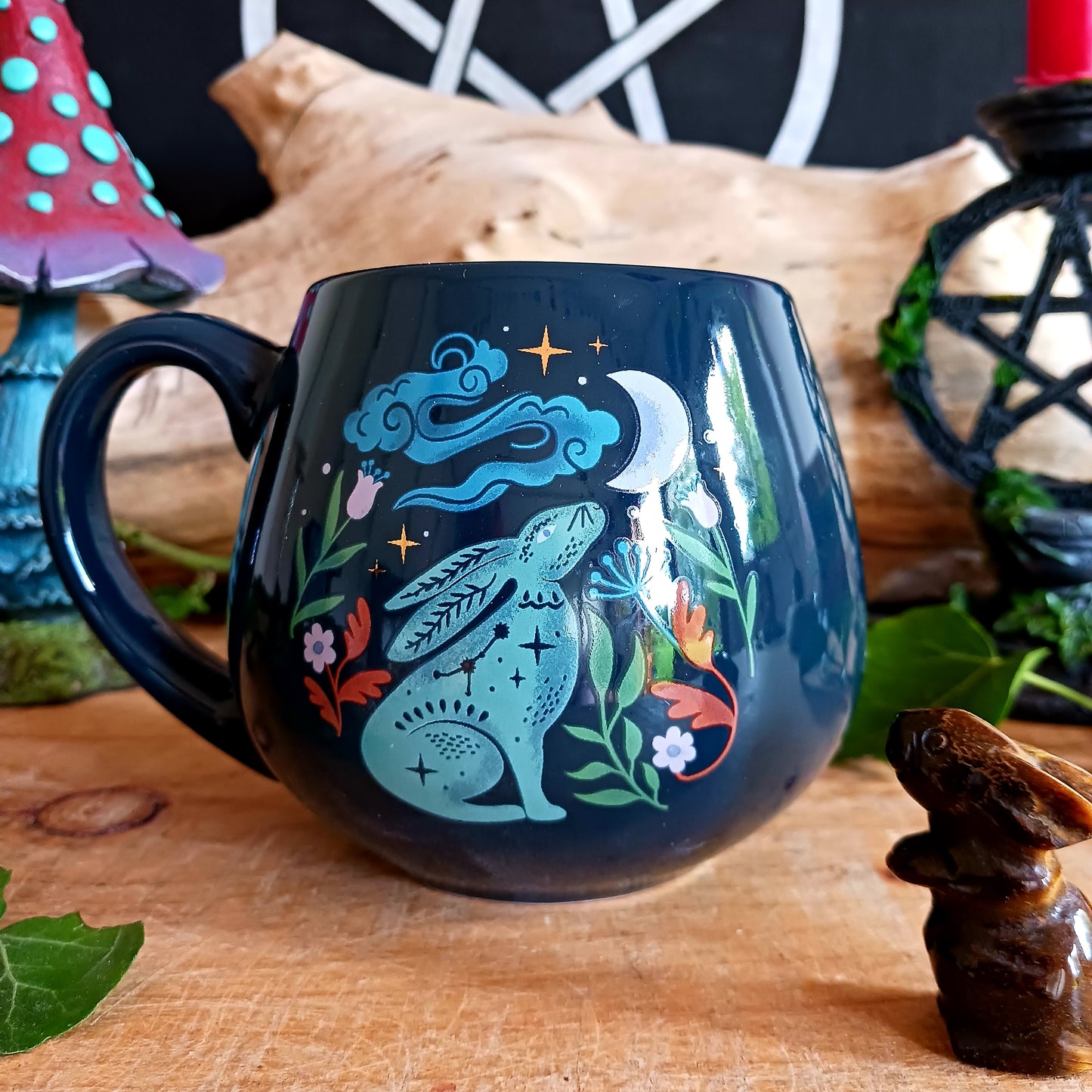 This mystical midnight hare ceramic mug makes a charming addition to a mug collection. Featuring a captivating design of a moon gazing hare underneath a starry night sky, this rounded mug will make every morning start with a touch of magic and wonder.