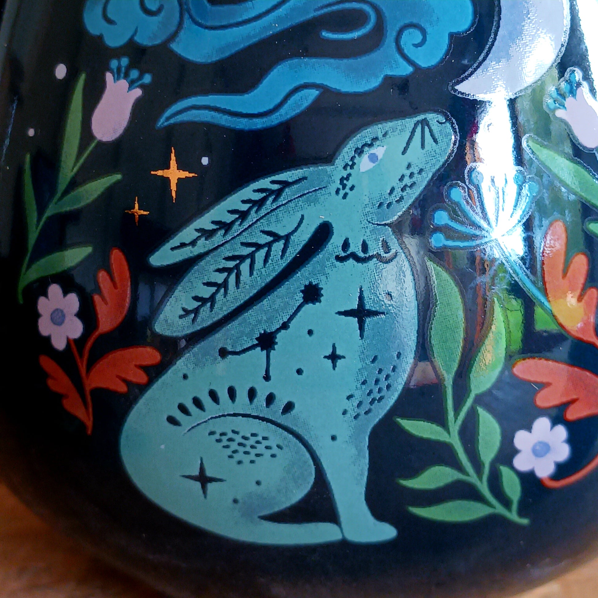 This mystical midnight hare ceramic mug makes a charming addition to a mug collection. Featuring a captivating design of a moon gazing hare underneath a starry night sky, this rounded mug will make every morning start with a touch of magic and wonder.