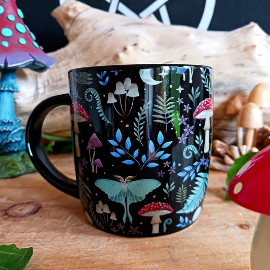 This black ceramic mug features a fabulous mystical forest print with magical mushrooms, toadstools and other forest flora & fauna. It's sure to start your morning off with a touch of magic and wonder!