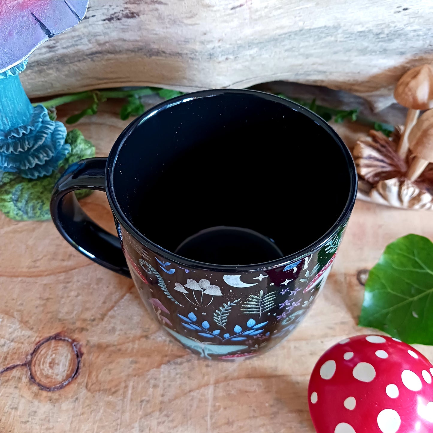 This black ceramic mug features a fabulous mystical forest print with magical mushrooms, toadstools and other forest flora & fauna. It's sure to start your morning off with a touch of magic and wonder!