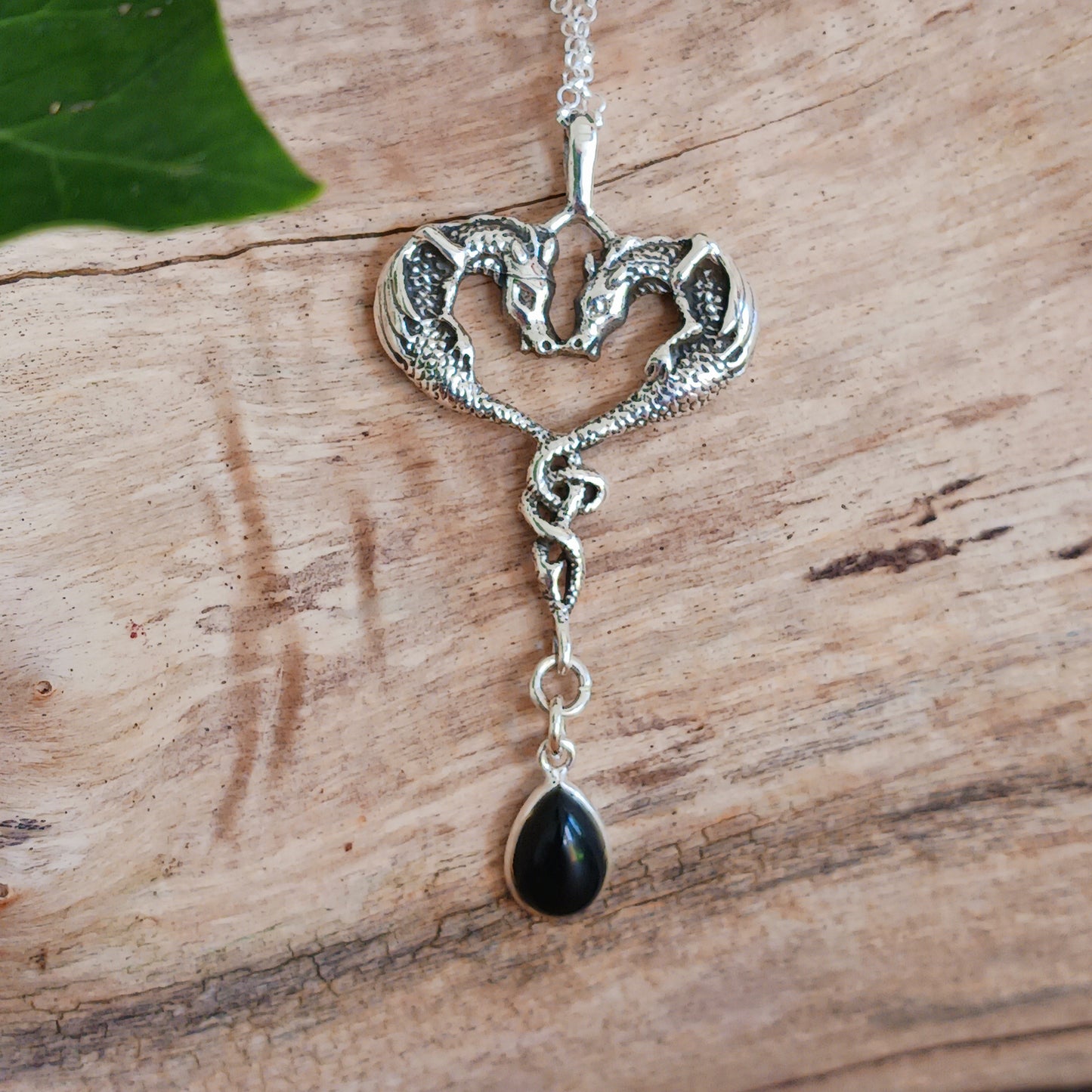 This beautifully detailed 925 Sterling Silver Dragon Heart Pendant is set with a Black Onyx Teardrop Gemstone. The two dragons are set in a loving, heart-shaped embrace and they become as one perfect being.