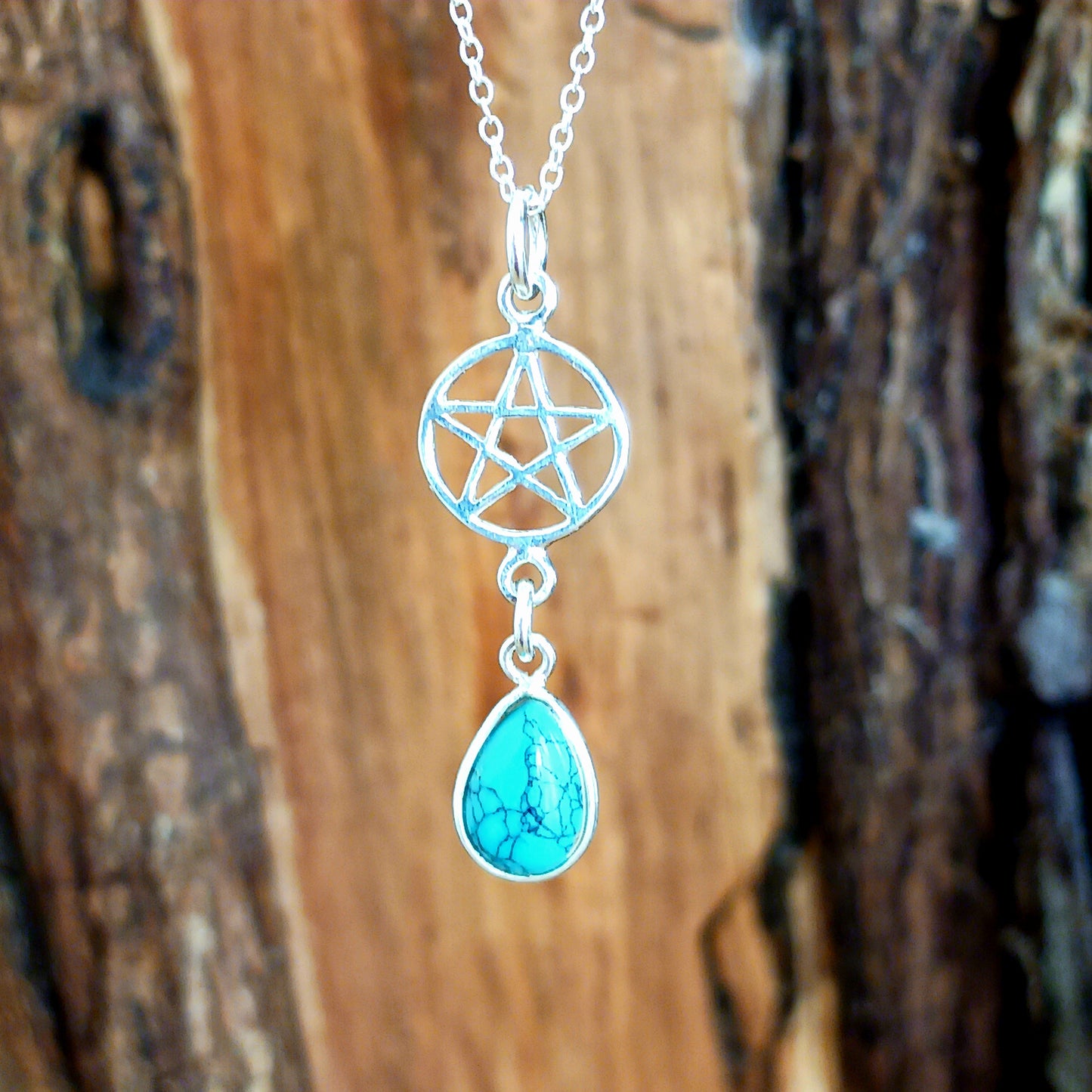 This handcrafted sterling silver Pentagram pendant has a beautiful Turquoise teardrop gemstone and is presented on a 925 sterling silver chain.