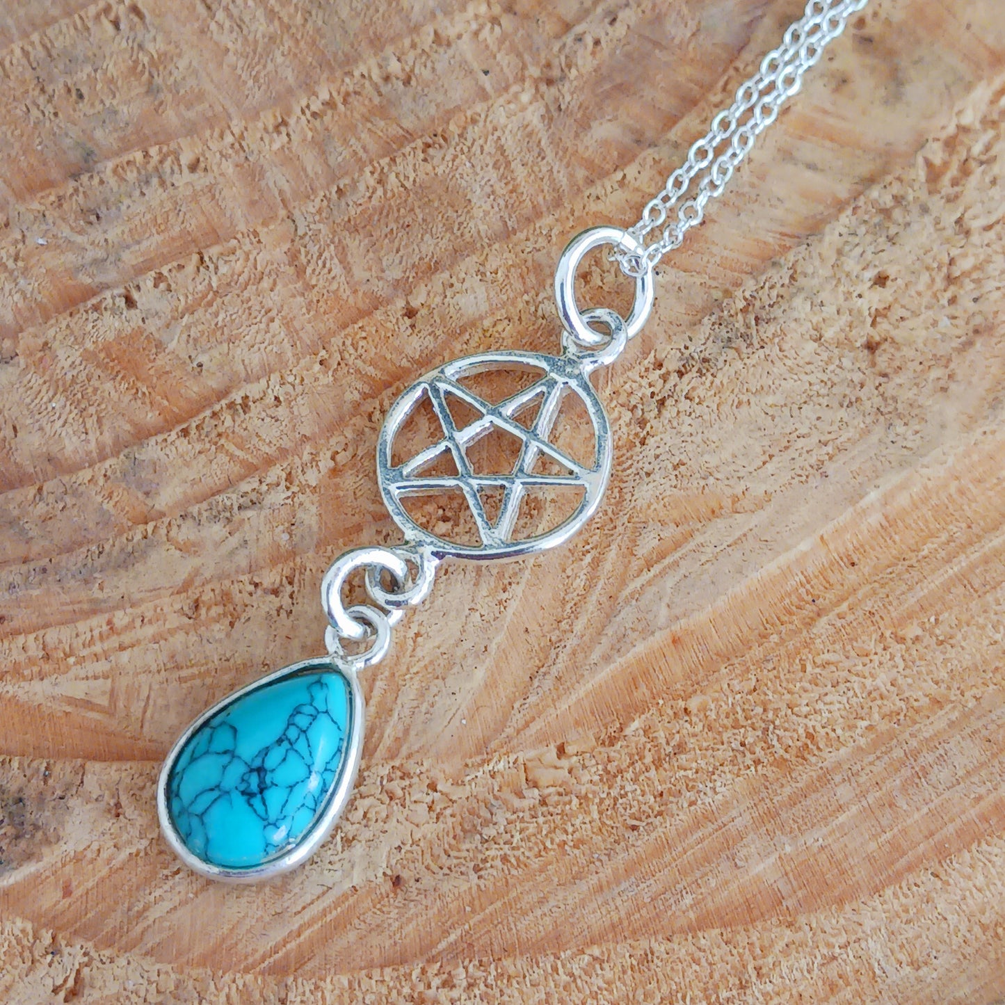 This handcrafted sterling silver Pentagram pendant has a beautiful Turquoise teardrop gemstone and is presented on a 925 sterling silver chain.