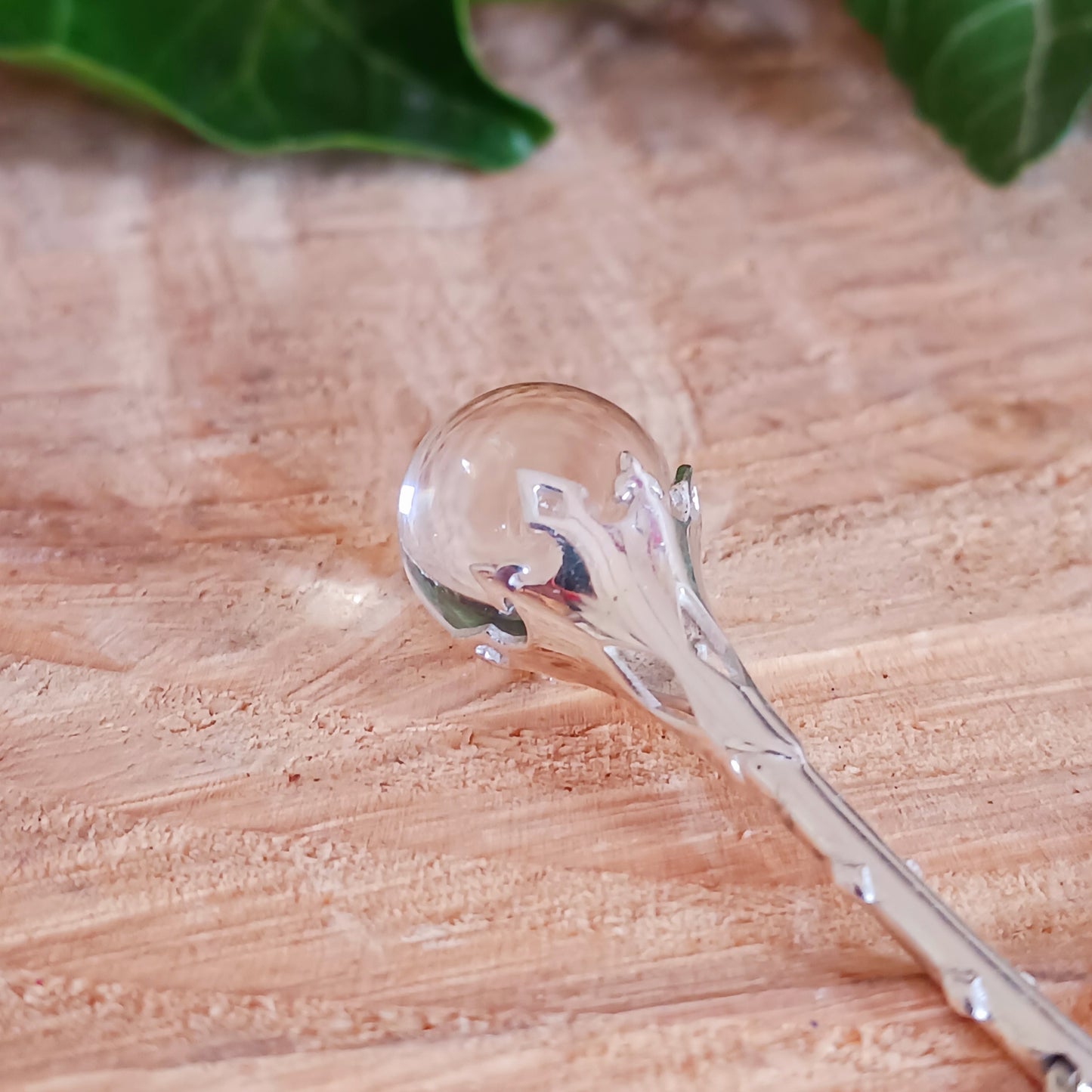 This Crystal Ball and Wand Pendant is made with with exquisite detail, featuring a 925 Sterling Silver Scrying Wand and a clear Quartz Crystal Ball.&nbsp; The clear Quartz Crystal Ball is set in sterling silver which has been carved in places to allow the light to shine down through the wand to give the ball more clarity.