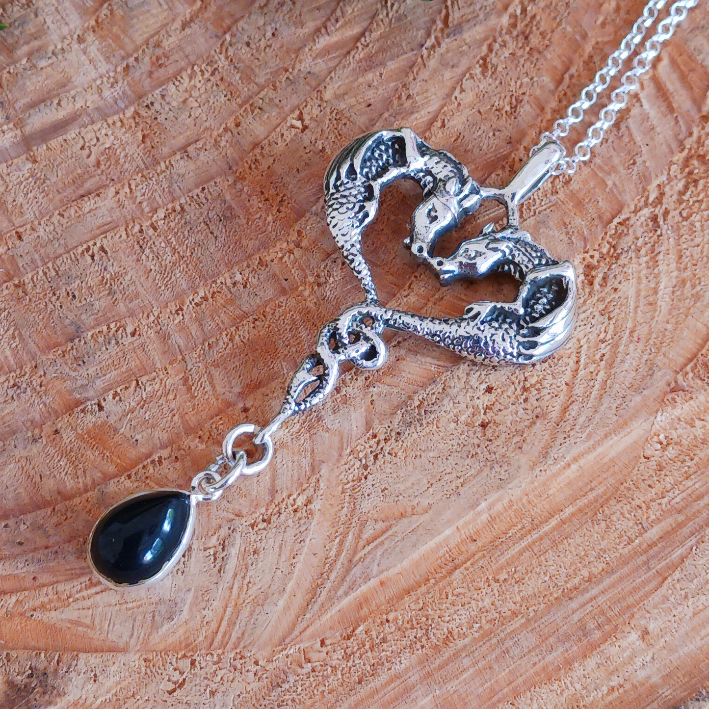 This beautifully detailed 925 Sterling Silver Dragon Heart Pendant is set with a Black Onyx Teardrop Gemstone. The two dragons are set in a loving, heart-shaped embrace and they become as one perfect being.