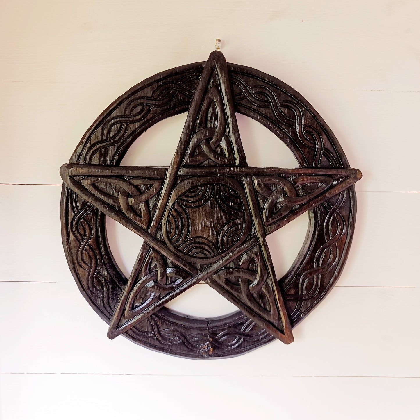 This beautiful wooden pentacle has been handcrafted and decorated with five Triquetra or endless knots which hold a great deal of symbolic meaning including a Christian representation of The Holy Trinity.