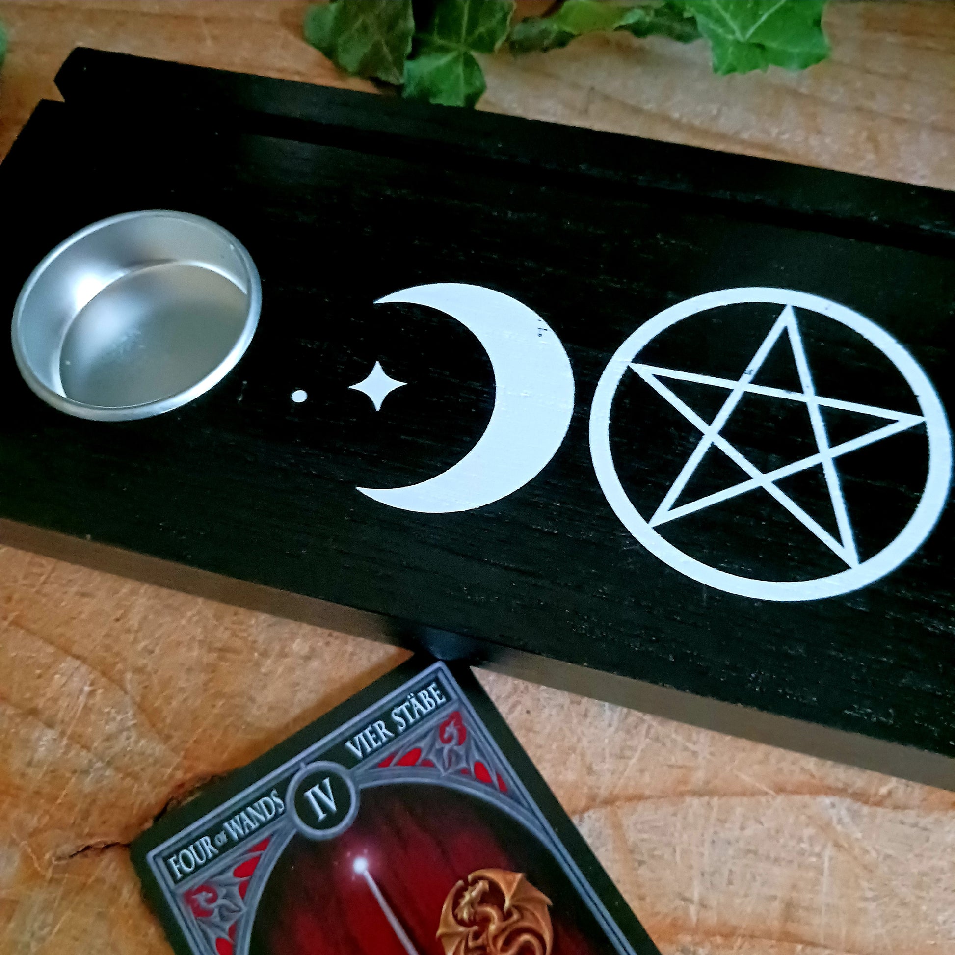 You can display your tarot card readings with this black wooden triple moon tarot card stand, that comes complete with two spaces for holding tealight candles to create ambiance, and allow the meaning of the cards to resonate.