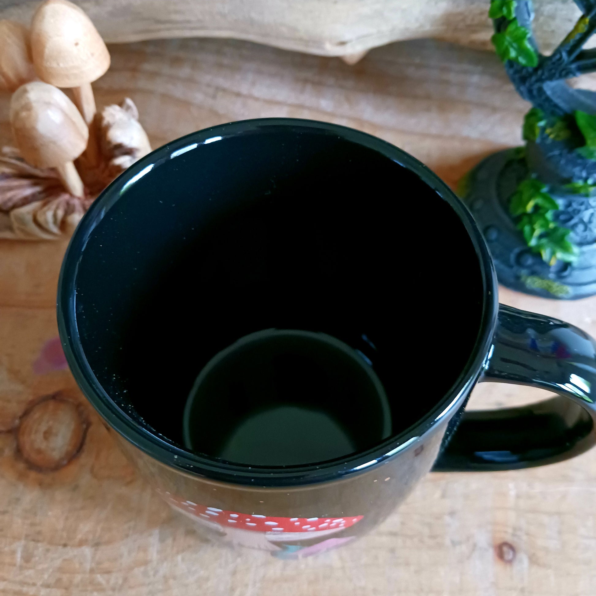 Add a touch of enchantment to your morning cuppa with this dark forest mushroom ceramic mug. This black ceramic mug features a captivating and intricate mushroom design, including a crescent moon and stars.