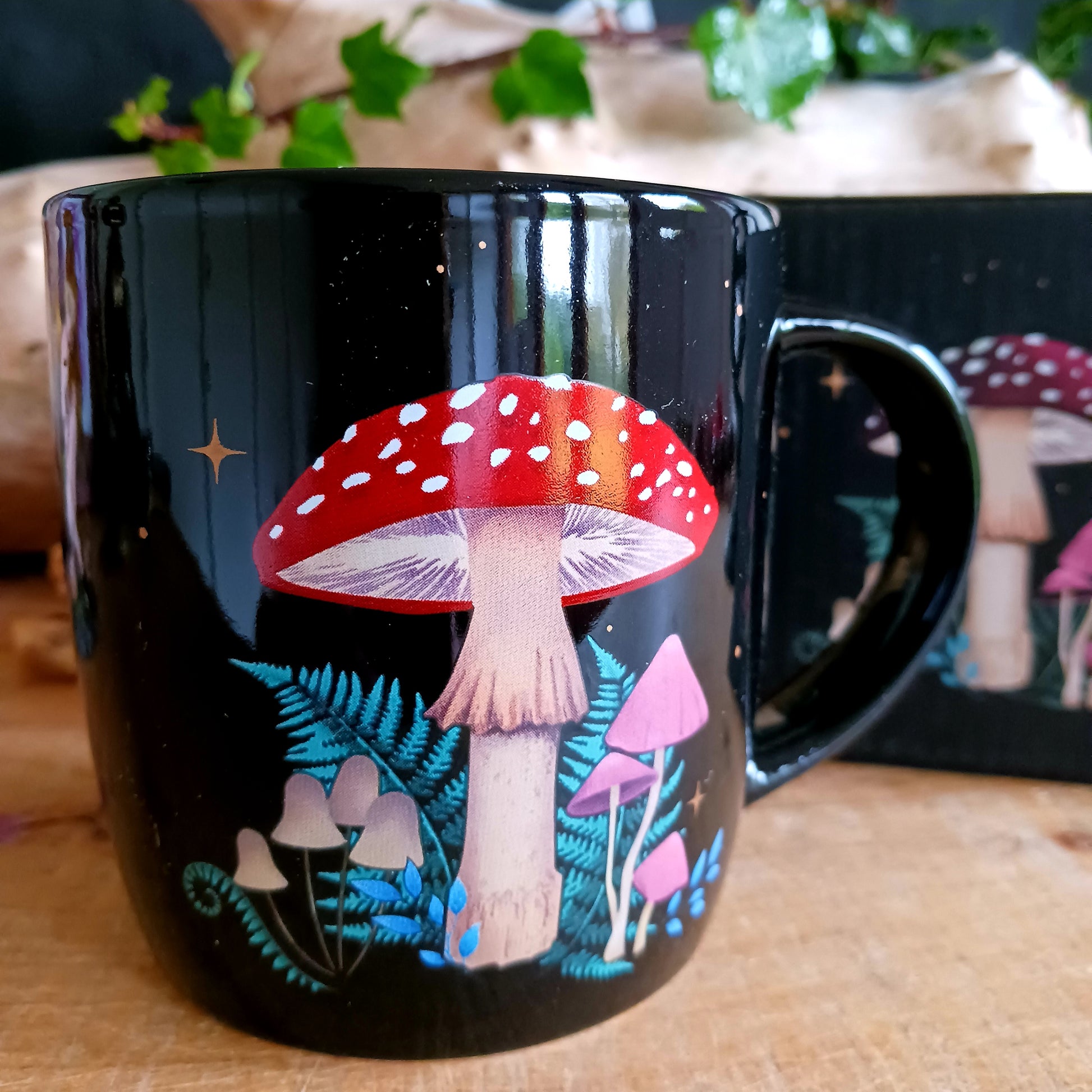 Add a touch of enchantment to your morning cuppa with this dark forest mushroom ceramic mug. This black ceramic mug features a captivating and intricate mushroom design, including a crescent moon and stars.