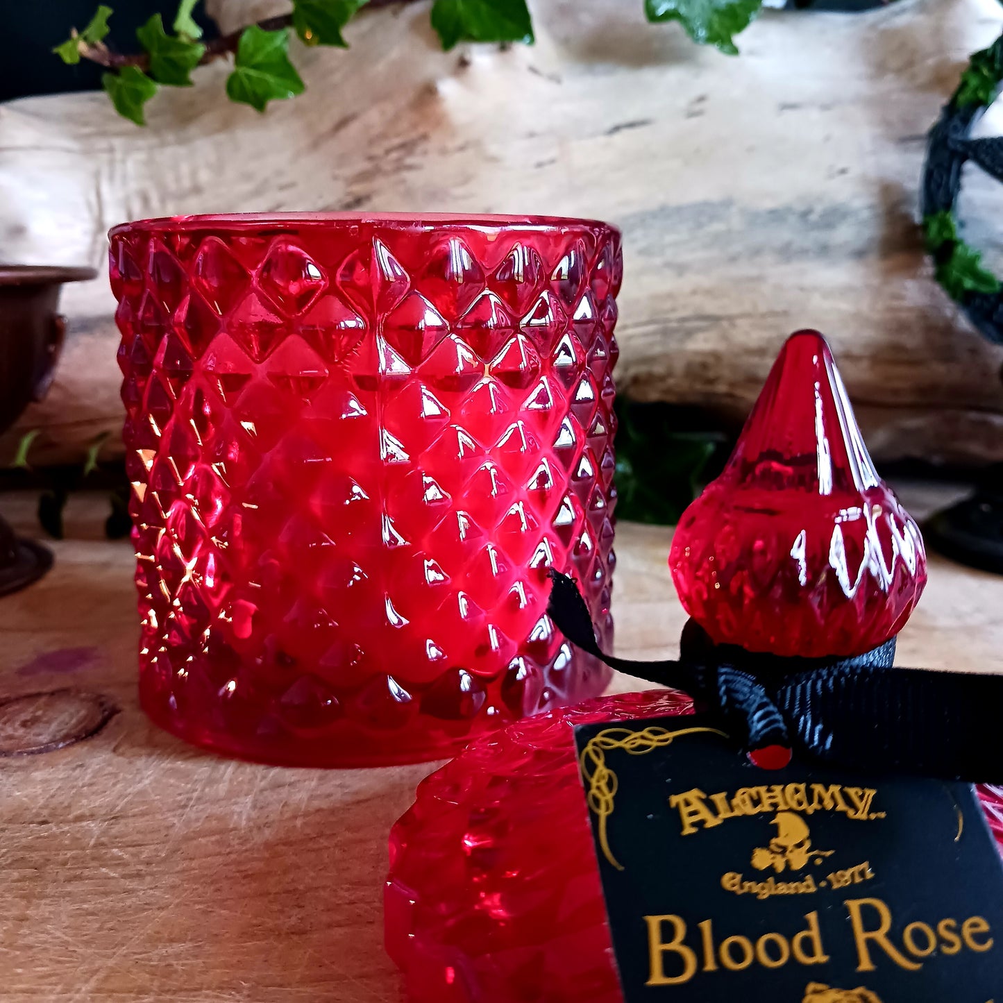 This blood rose red, vintage inspired, lidded candle jar encapsulates a sensual scented candle. Light the candle and the dark sensual aroma of the 'Blood Rose' will envelop your boudoir! Once the candle has burnt, this stunning, cut glass effect jar can then be used to keep safe your trinkets and treasures.