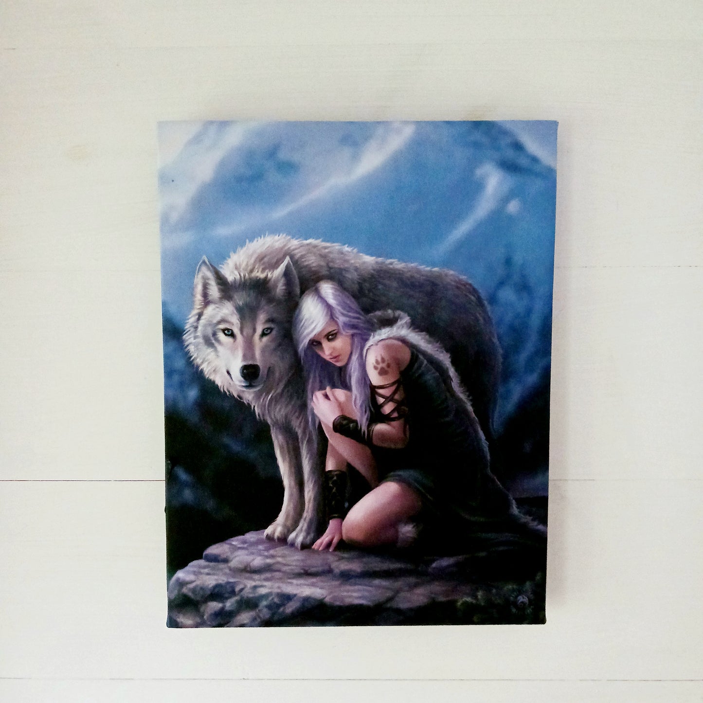 This stunning canvas by Anne Stokes entitled Protector, features a bold wolf protector design that is sure to add strength, power, and protection to any space. The detailed work of world-renowned artist Anne Stokes ensures that the protector is a one-of-a-kind piece, expertly crafted for lasting quality and beauty.