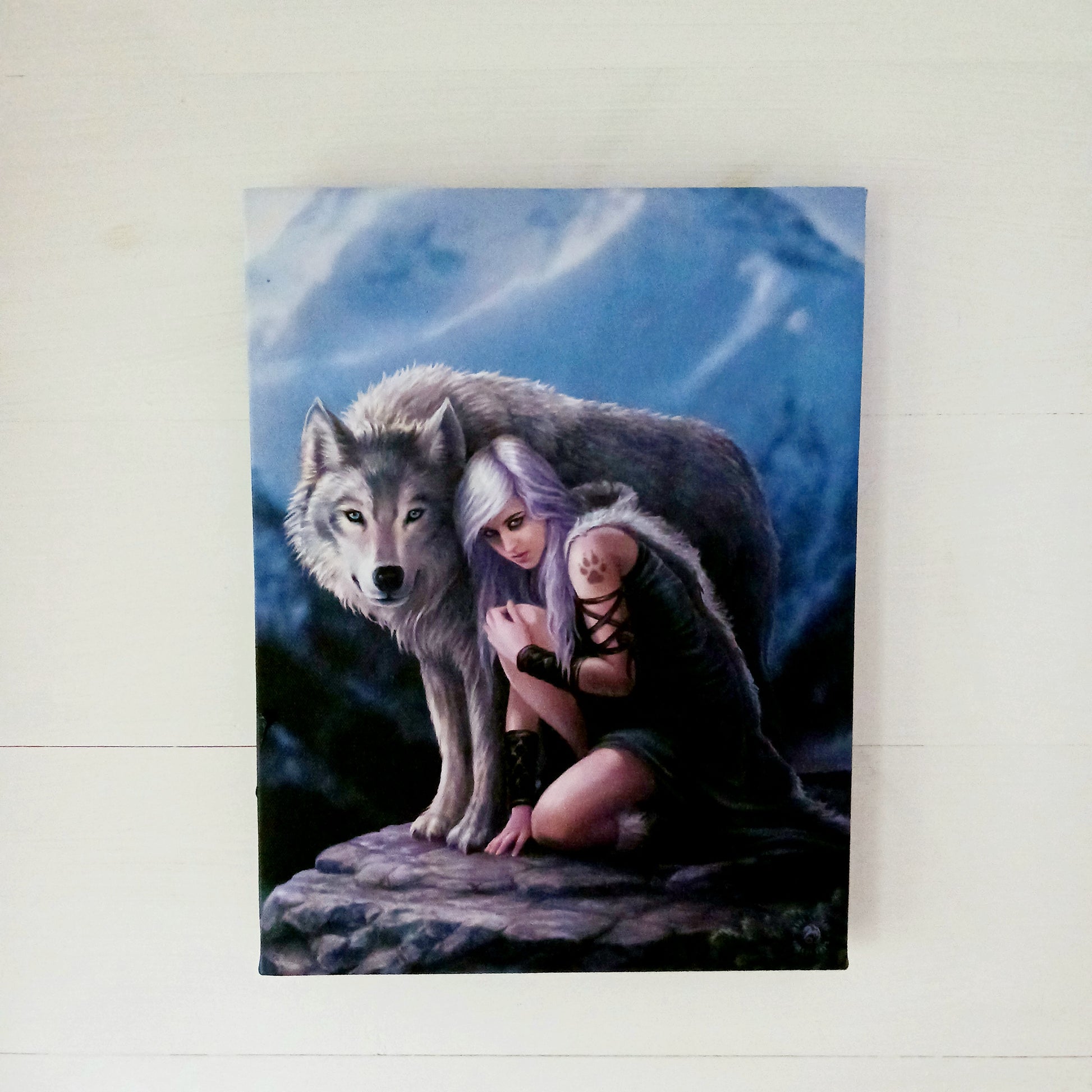 This stunning canvas by Anne Stokes entitled Protector, features a bold wolf protector design that is sure to add strength, power, and protection to any space. The detailed work of world-renowned artist Anne Stokes ensures that the protector is a one-of-a-kind piece, expertly crafted for lasting quality and beauty.