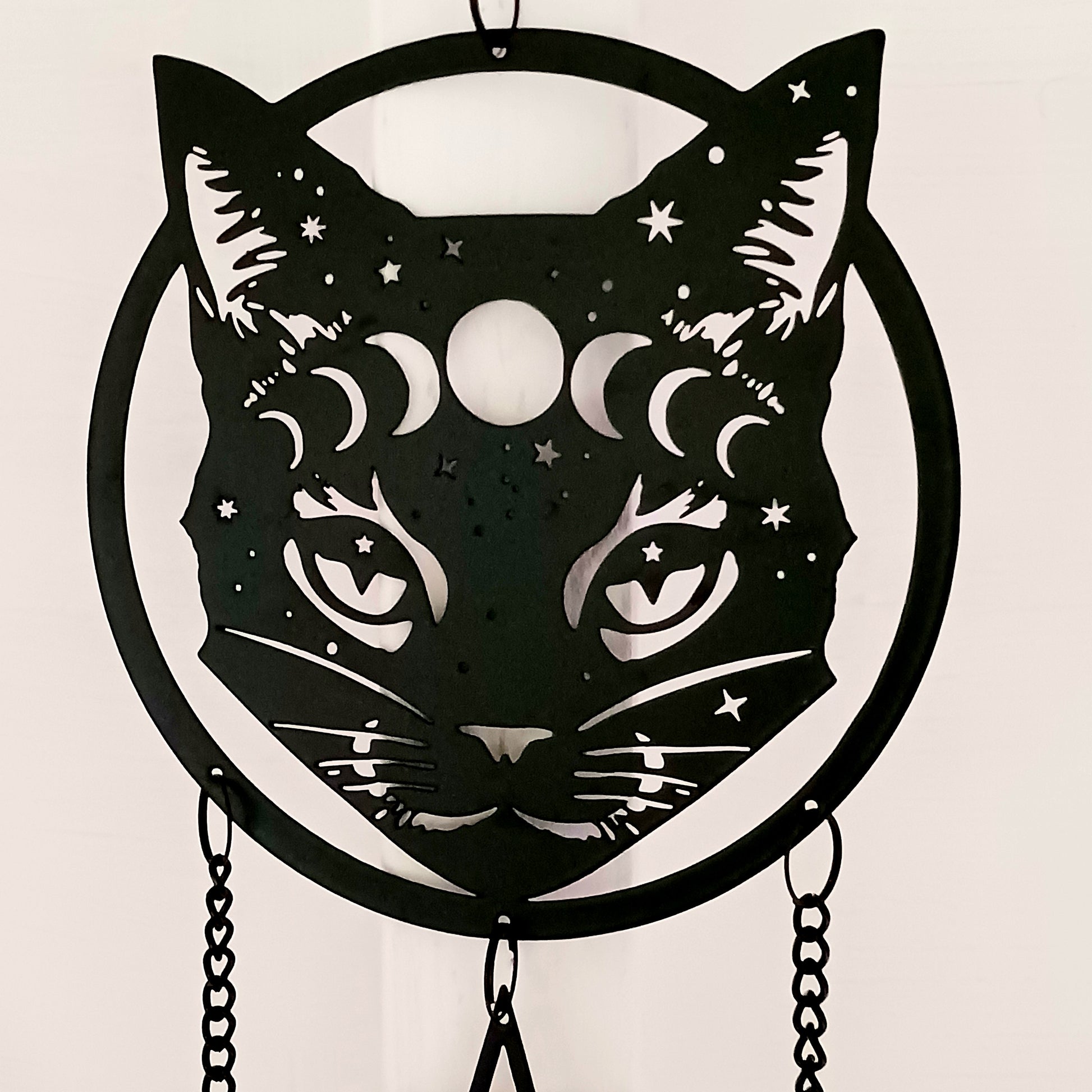 From the Alchemy England hanging decoration collection, this magic black cat face with moon phase and stars has three magical chimes!