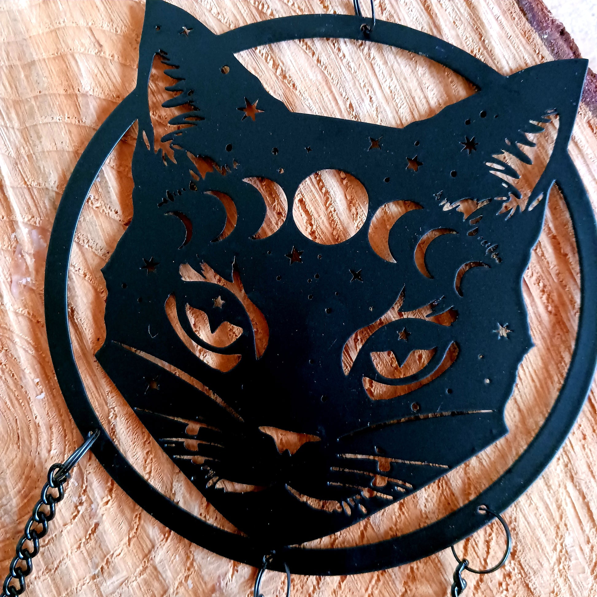 From the Alchemy England hanging decoration collection, this magic black cat face with moon phase and stars has three magical chimes!