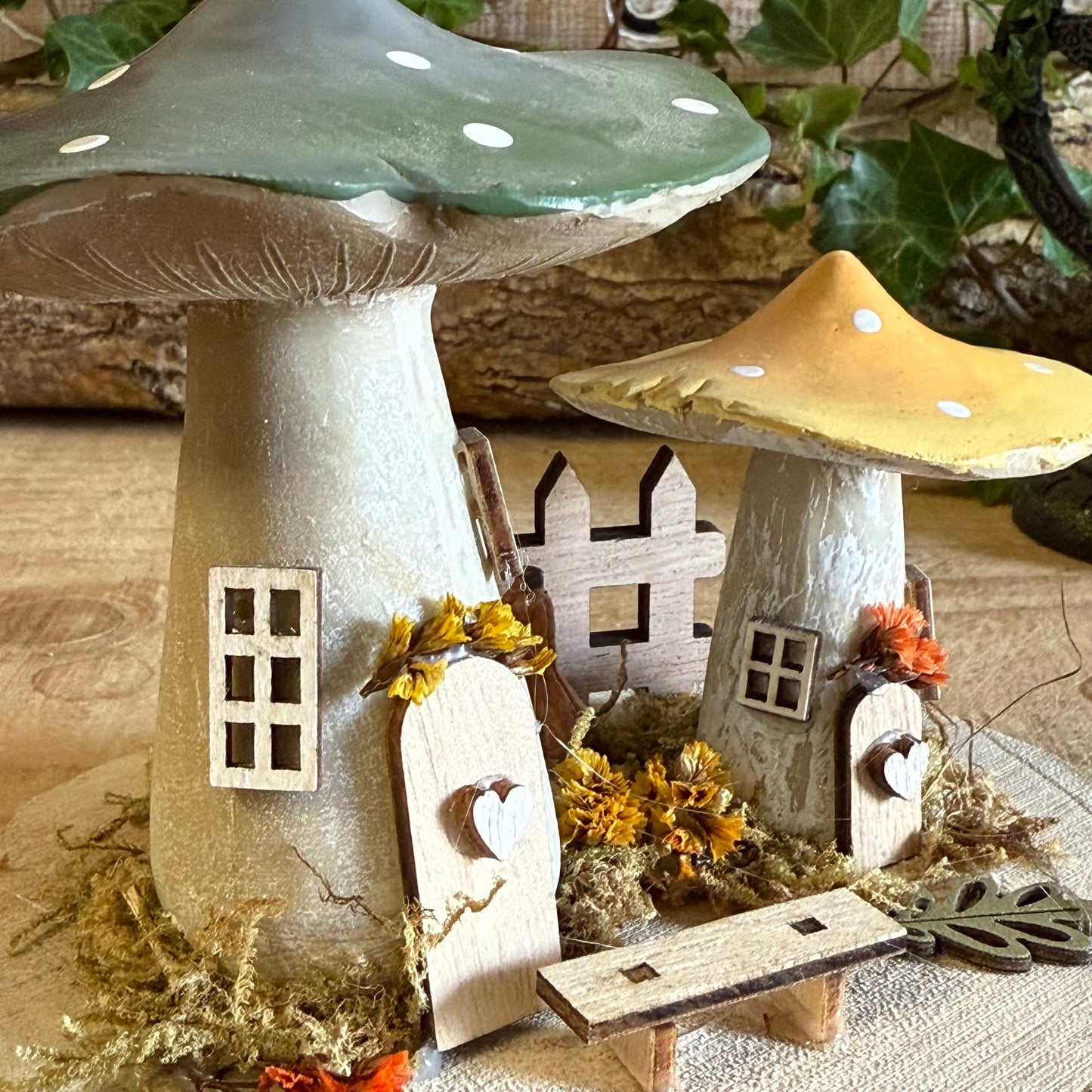 Discover the gentle magic of our Folk Art Mushroom Two Cottages (Medium) — a charming pair of fairy houses brought to life with hand painted folk art detail. Each piece is crafted with care, featuring vibrant colours, floral patterns, and rustic textures that capture the joy and simplicity of woodland living.
