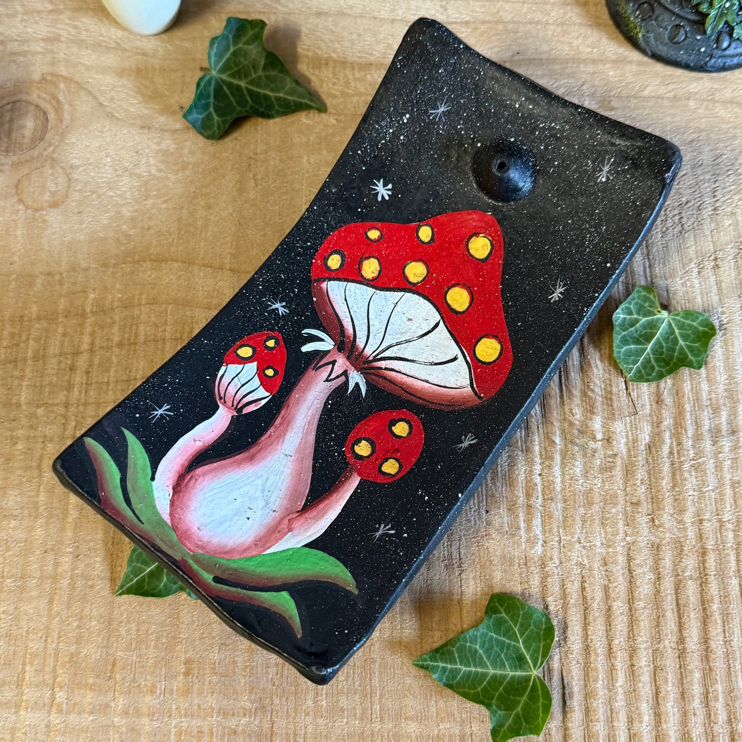 Invite a sprinkle of woodland magic into your home with our Terracotta Mushroom Incense Holder, lovingly handcrafted in Bali, Indonesia. Each piece is shaped from natural terracotta and hand painted with intricate detail, capturing the rustic beauty of forest toadstools kissed by the morning dew.