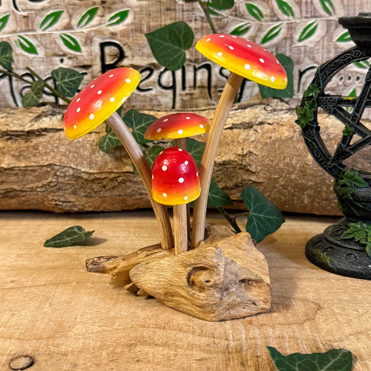 Hand carved red wooden mushrooms on rustic base. Perfect for fairy gardens, cottage-style décor, and whimsical woodland displays in any home.