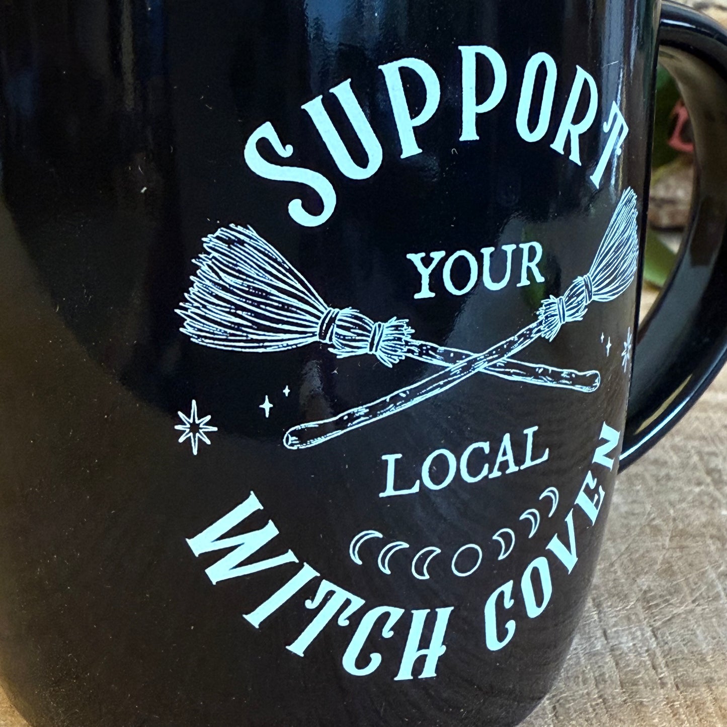 Show your support for all things magical with this black ceramic mug featuring crossed broomsticks and the phrase “Support Your Local Witch Coven.” Perfect for modern witches, mystical coffee lovers, and anyone who proudly backs their coven crew. With a 320ml capacity, it’s ideal for coffee, tea, or any magical potion. Microwave and dishwasher safe, this mug combines practicality with witchy style, making it a must-have gift or a charming addition to your own mystical collection.