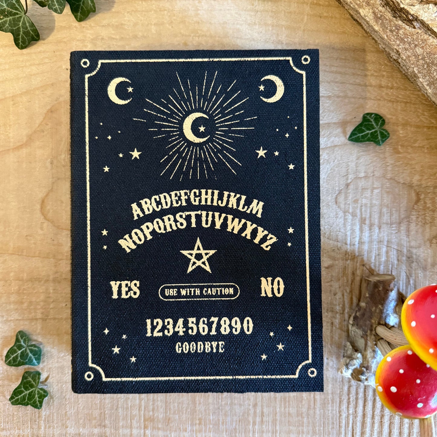 Store keys and jewellery in the Talking Board book shaped storage box. Black and gold mystical design from the Summon the Spirits collection.