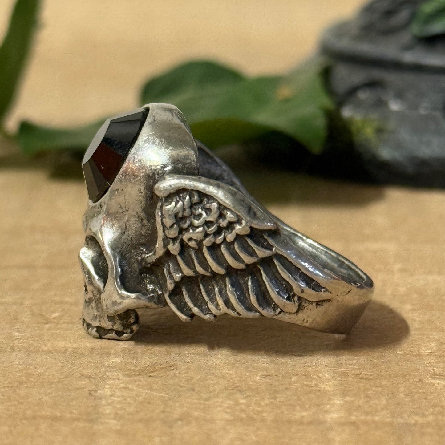 Invoke the balance of strength and spiritual awareness with the Alchemy Gothic Skull and Wings Ring. Crafted from durable black pewter, this ring showcases a detailed skull with outstretched wings, embodying transformation, mortality, and the freedom of the soul.

An embossed black stone rests at its heart, radiating grounding energy and mindfulness. This gothic accessory merges elegance with spiritual symbolism, making it ideal for those who seek both style and contemplation.

Designed to fit size U, this 