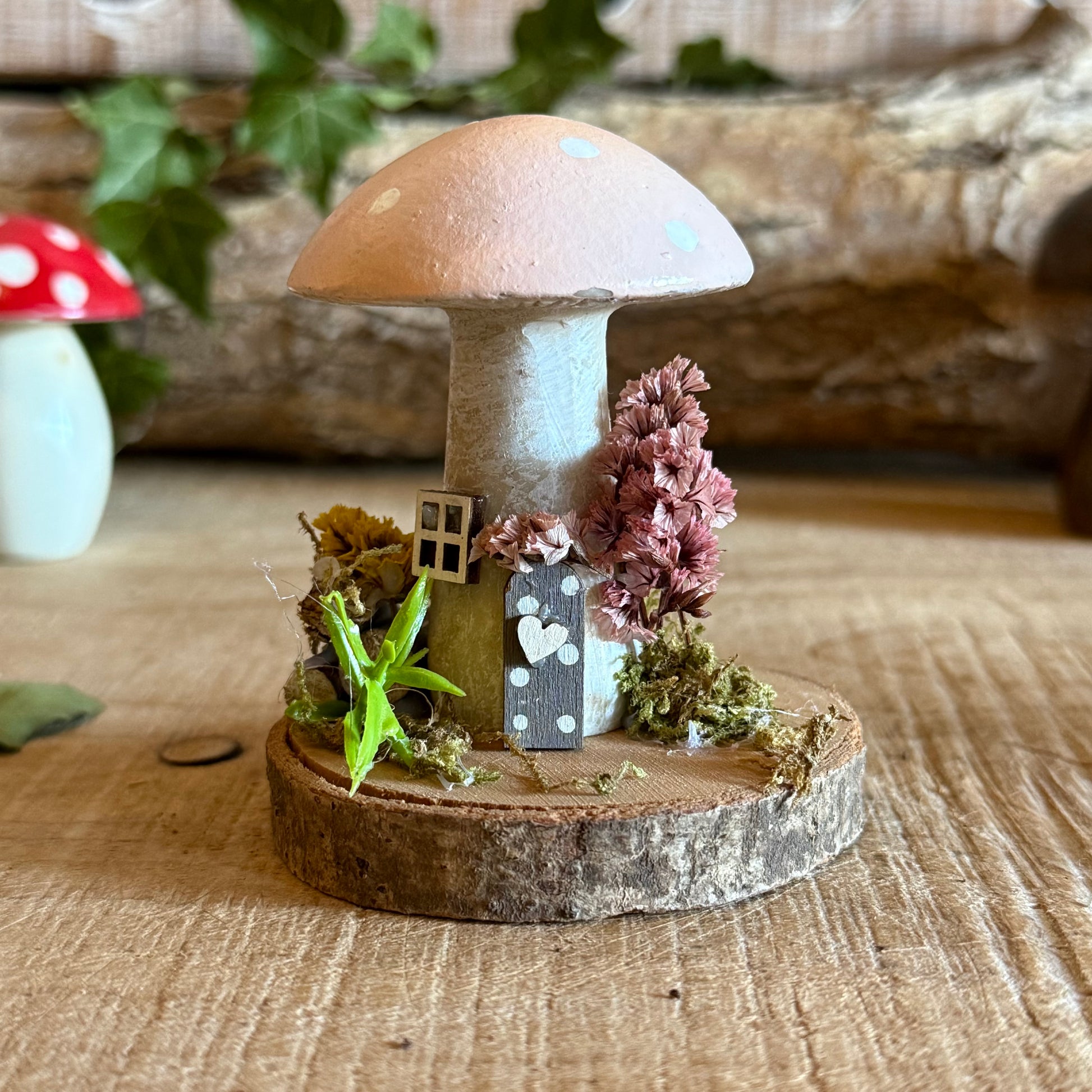 Step into a storybook world with our Spring Folk Art Mushroom Cottage, a charming miniature home inspired by blooming meadows and enchanted forests. Each cottage is hand painted with loving detail, featuring bright spring tones and floral folk art patterns that celebrate renewal and the magic of nature’s awakening.