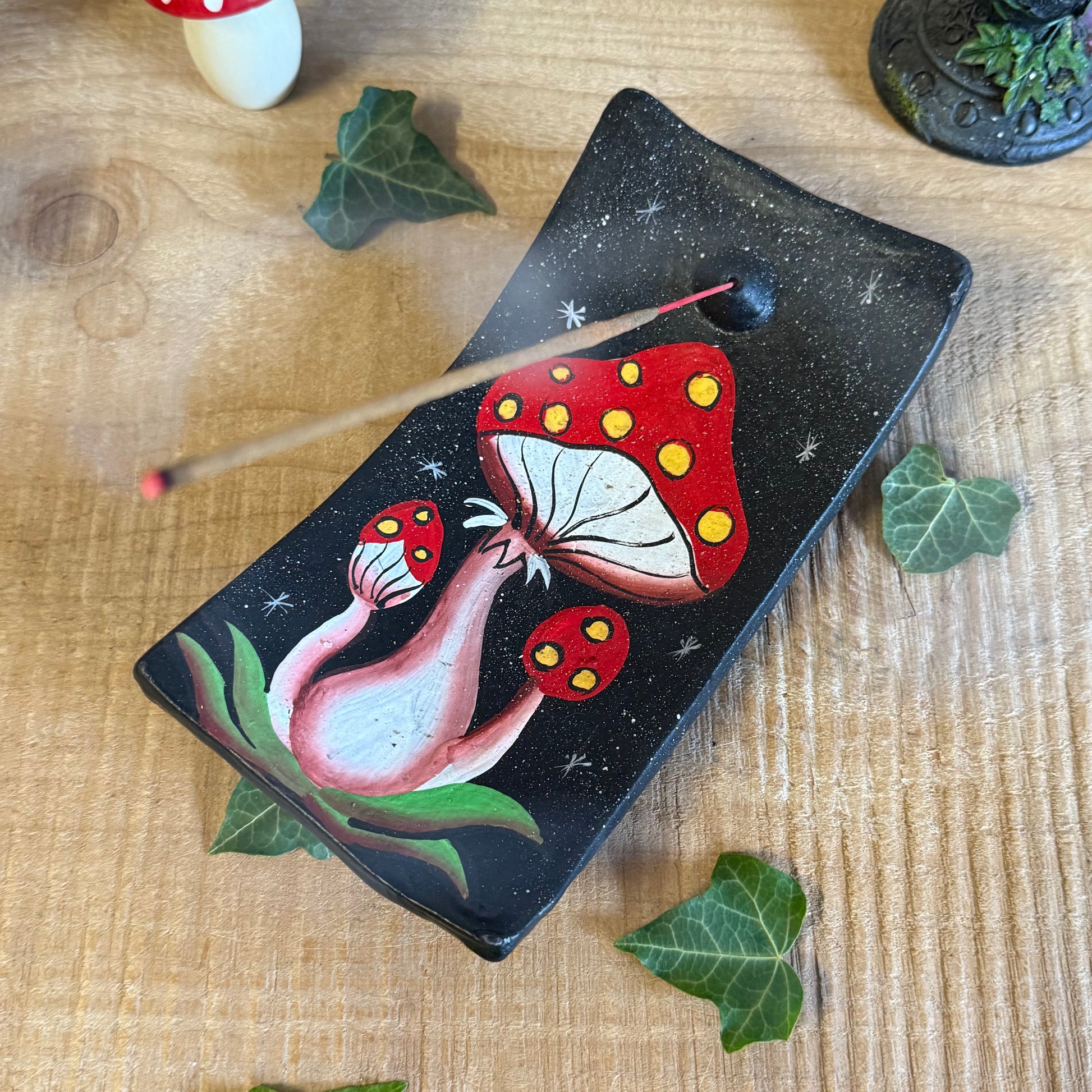 Invite a sprinkle of woodland magic into your home with our Terracotta Mushroom Incense Holder, lovingly handcrafted in Bali, Indonesia. Each piece is shaped from natural terracotta and hand painted with intricate detail, capturing the rustic beauty of forest toadstools kissed by the morning dew.