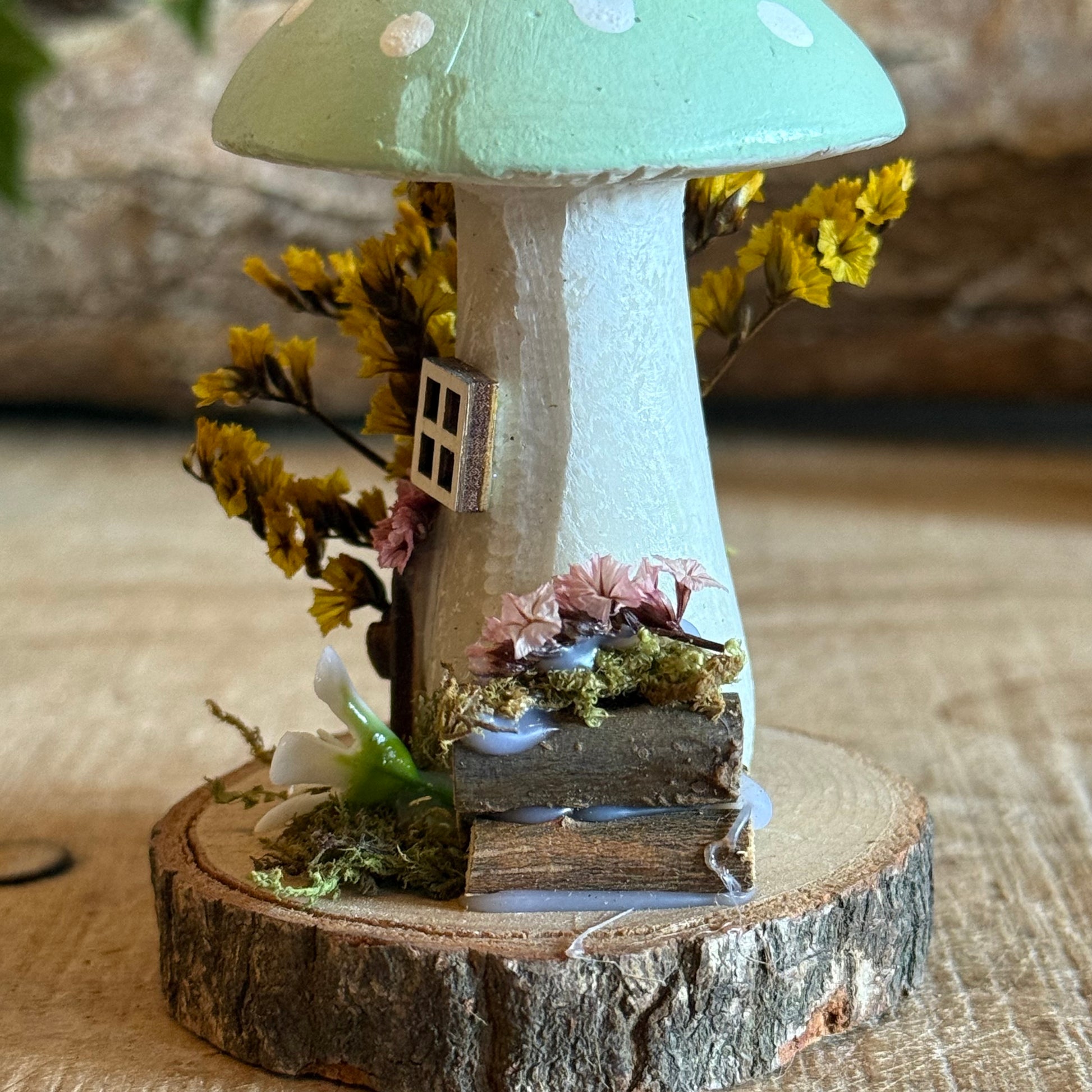 Step into a storybook world with our Spring Folk Art Mushroom Cottage, a charming miniature home inspired by blooming meadows and enchanted forests. Each cottage is hand painted with loving detail, featuring bright spring tones and floral folk art patterns that celebrate renewal and the magic of nature’s awakening.