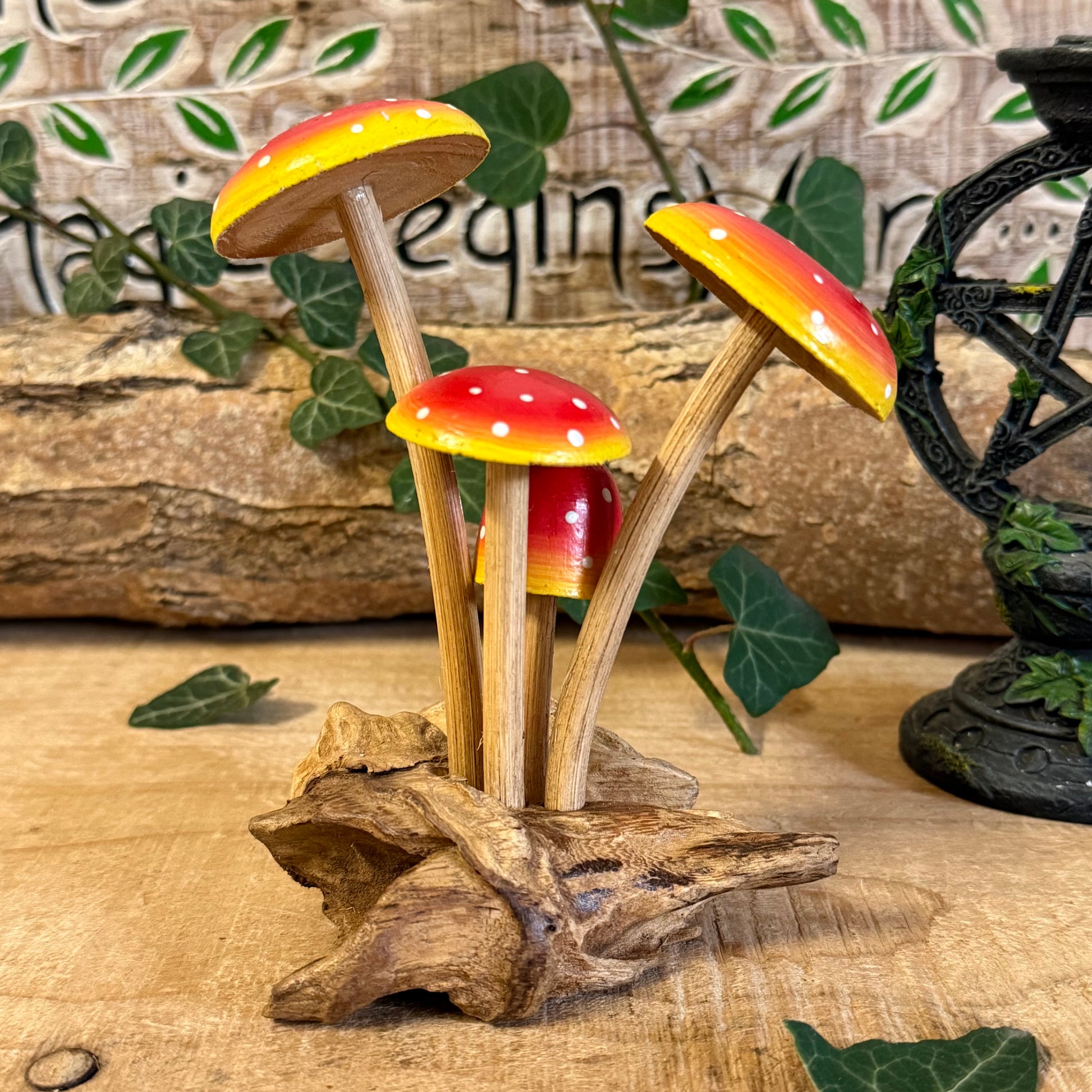 Hand carved red wooden mushrooms on rustic base. Perfect for fairy gardens, cottage-style décor, and whimsical woodland displays in any home.