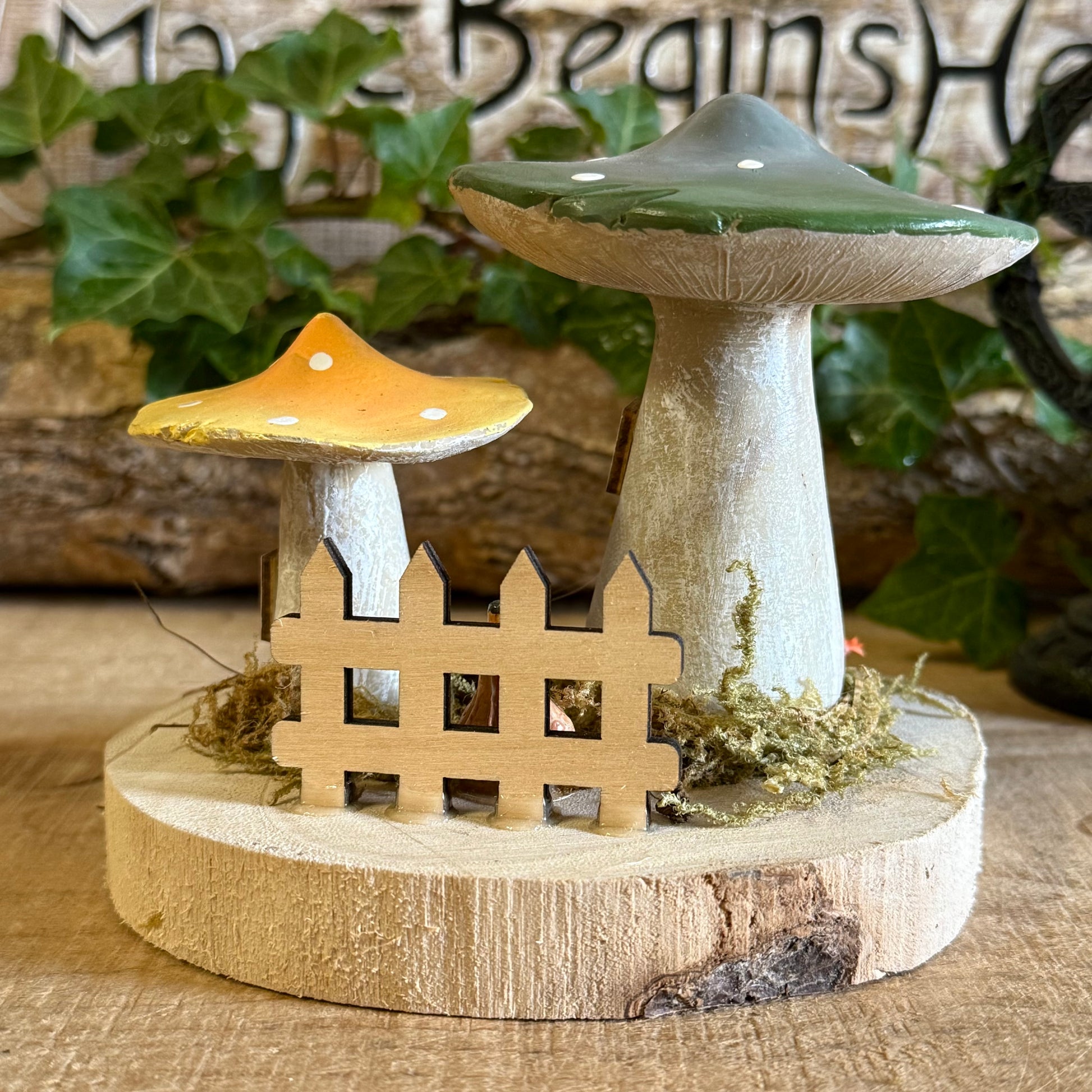 Discover the gentle magic of our Folk Art Mushroom Two Cottages (Medium) — a charming pair of fairy houses brought to life with hand painted folk art detail. Each piece is crafted with care, featuring vibrant colours, floral patterns, and rustic textures that capture the joy and simplicity of woodland living.