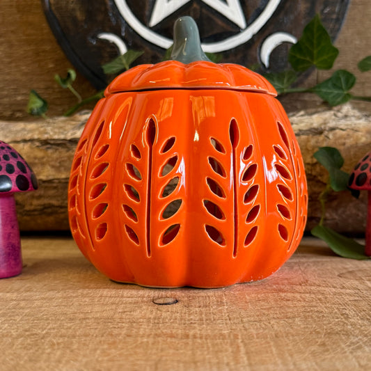 Add a touch of autumn elegance to your home with this pumpkin-shaped oil burner and wax warmer from Orange Leaf. Crafted with charming cut-out details, it creates a cosy, ambient glow perfect for chilly autumn evenings. Ideal for melting autumn-themed wax melts or fragrance oils, it fills your home with comforting seasonal scents. Always remove the lid when in use. A decorative and practical piece, this oil burner brings both style and warmth to your seasonal décor.