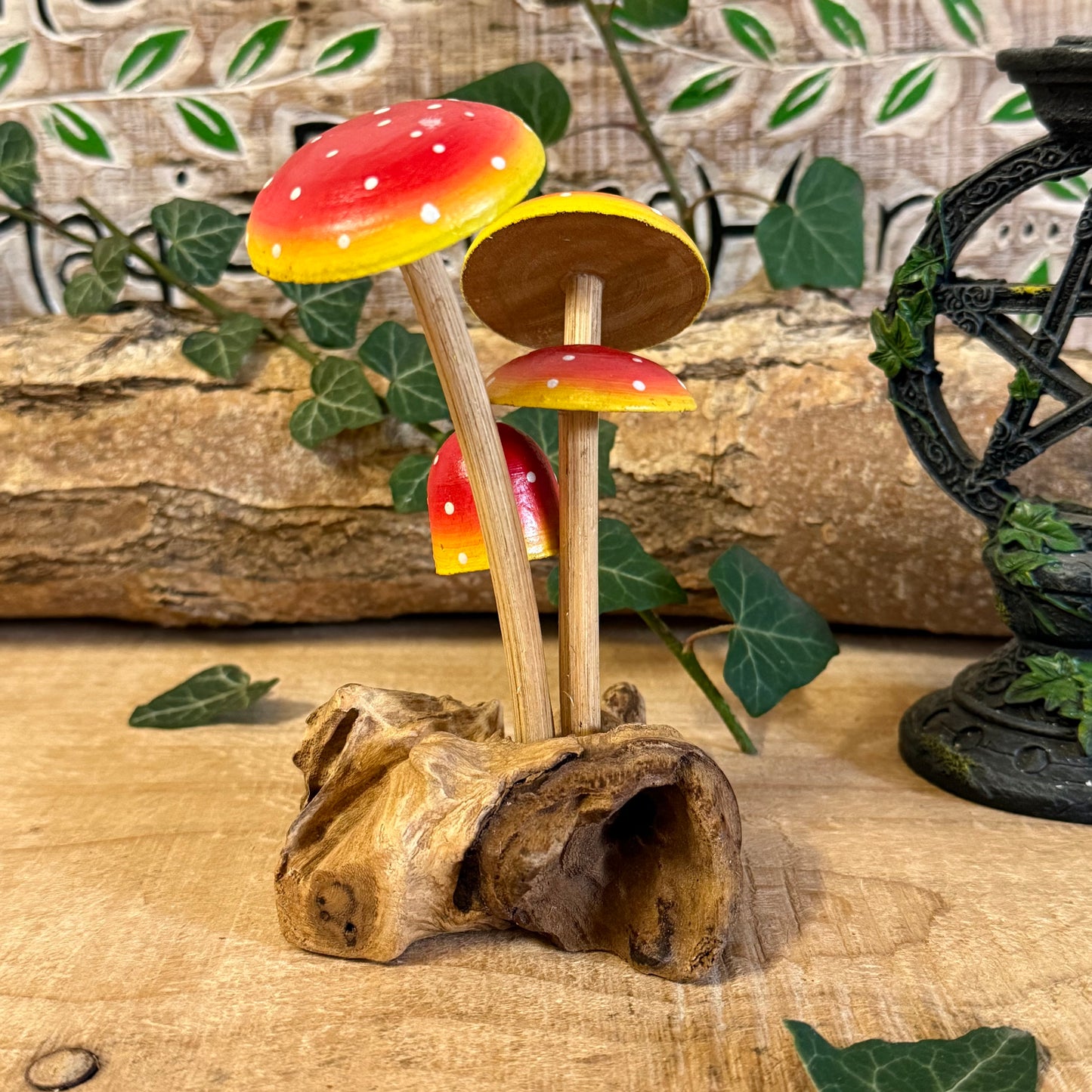 Hand carved red wooden mushrooms on rustic base. Perfect for fairy gardens, cottage-style décor, and whimsical woodland displays in any home.
