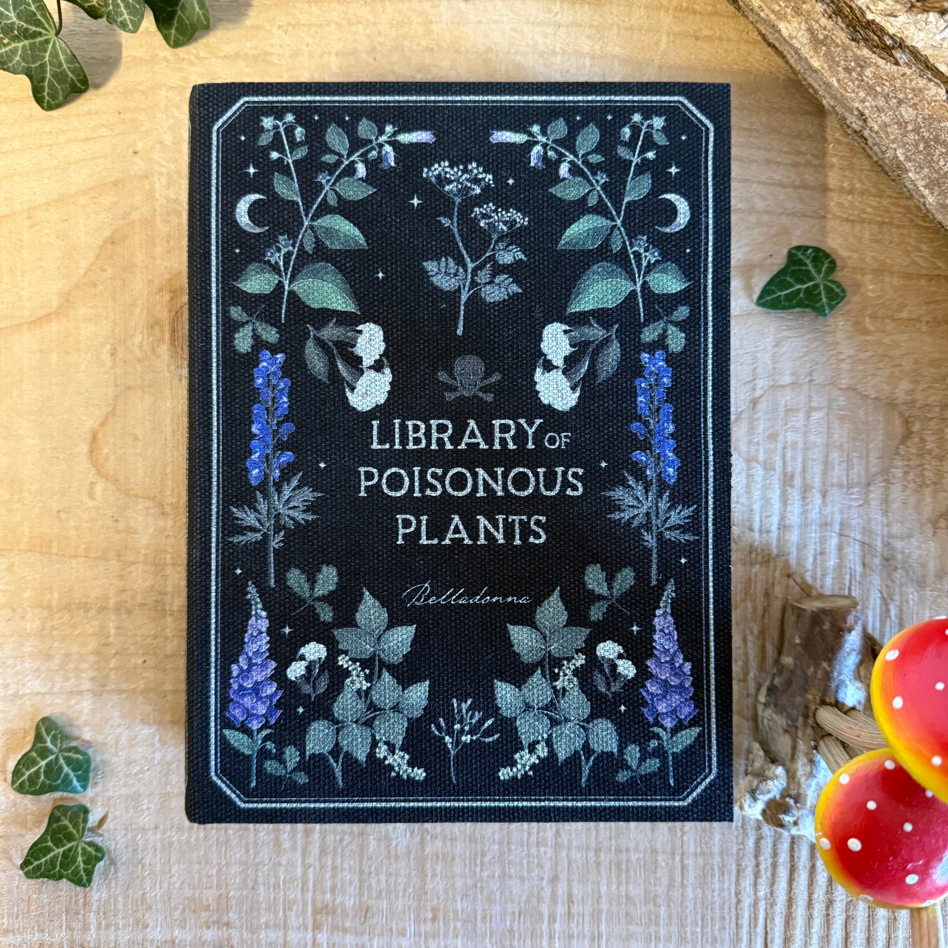 Hide treasures in the Library of Poisonous Plants book shaped storage box. Gothic botanical MDF keepsake box for secret storage and decor.