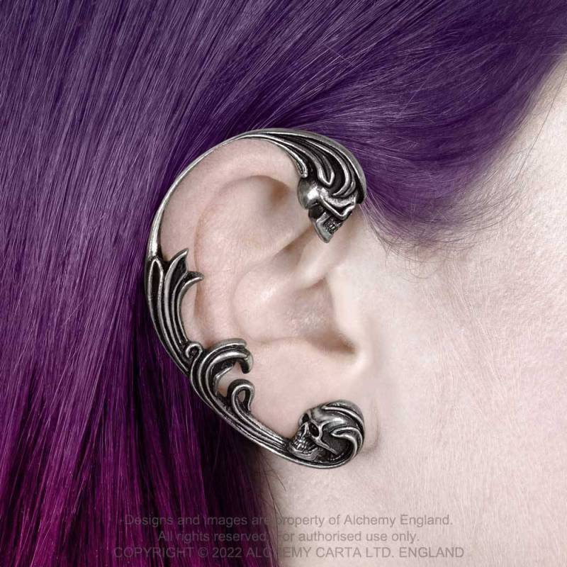 A breath-taking ear wrap (Ear Jewellery) handmade in antiqued and polished pewter featuring two baroque encased skulls.