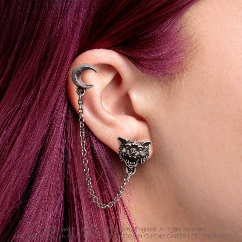 A sullen, skulking lone wolf, sensitive to the nuanced force, awaits a full moon for freedom from restraint.  This enchanting ear jewellery features a crescent moon symbolically linked to a howling wolf by a delicate chain. Perfect for an ear with multiple piercings. Choose how you want to style your ear!