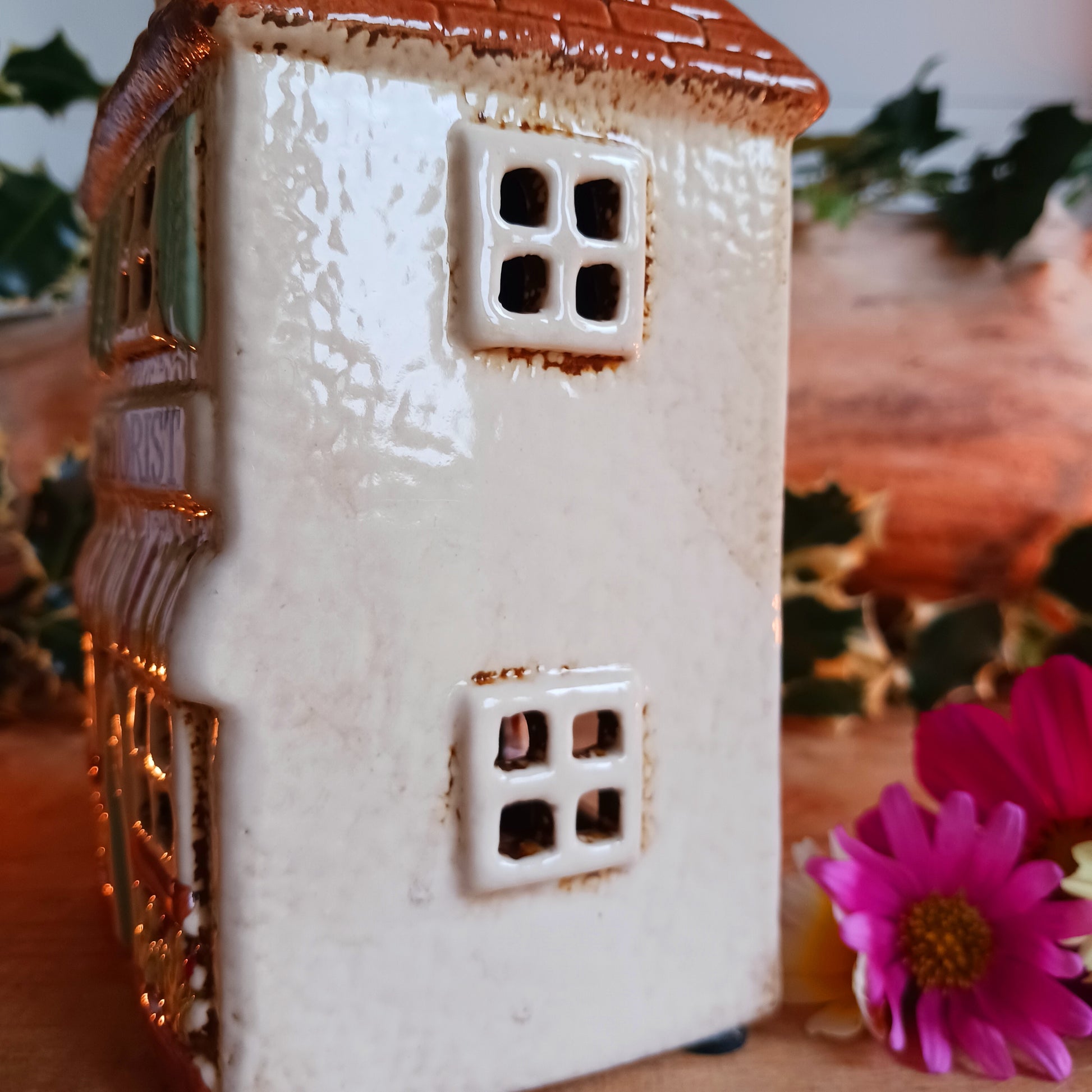 Handcrafted in the Village Pottery workshop, this Florist Tealight Holder is a true collectible from the Shudehill Collection. Made from fine ceramic with intricate detailing, it captures the nostalgic charm of a festive florist shop in a snow-dusted winter village scene.