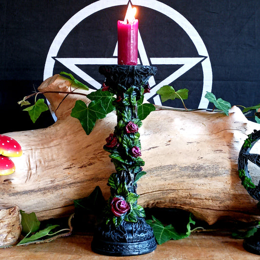 Add a touch of dark elegance to your home with the Scarlet Rose Gothic Candlestick Holder. Beautifully crafted with a stone pillar design, this striking ornament features intricate red roses and green vegetation, creating a mysterious gothic aesthetic that makes a statement in any room.