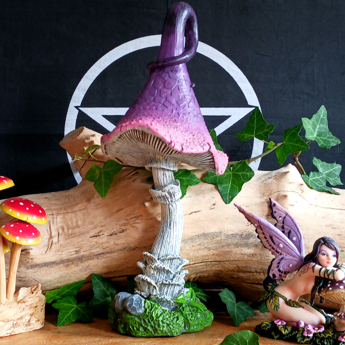 Bring a touch of magic and whimsical charm to your home with Twizzle Tumblethorne, a wonderfully quirky purple mushroom sculpture perfect for lovers of fantasy, fairies and nature-inspired decor.