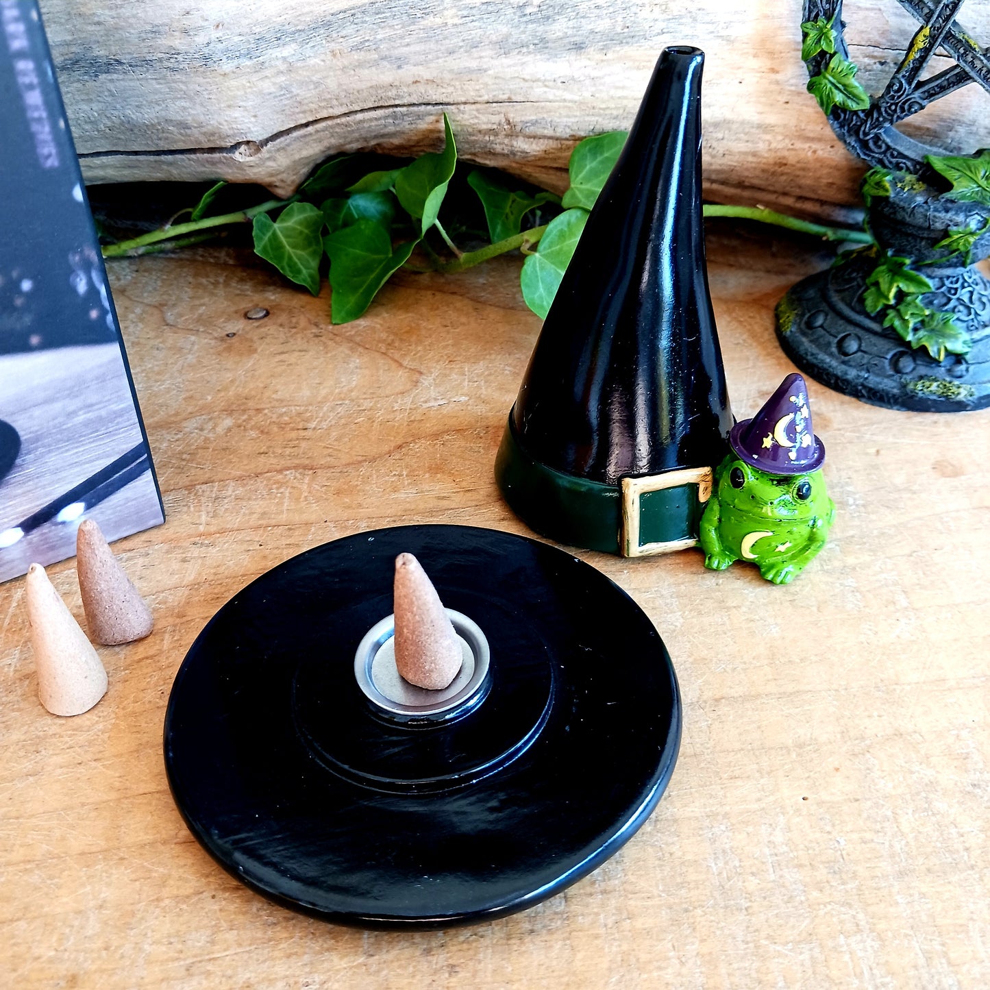 Add a touch of playful magic to your home with this charming Magic Toad & Witch Hat Incense Cone Holder. Made from resin, this quirky incense burner features a classic witch’s hat accompanied by a cute toad, creating a fun and mystical piece of witchy home décor.