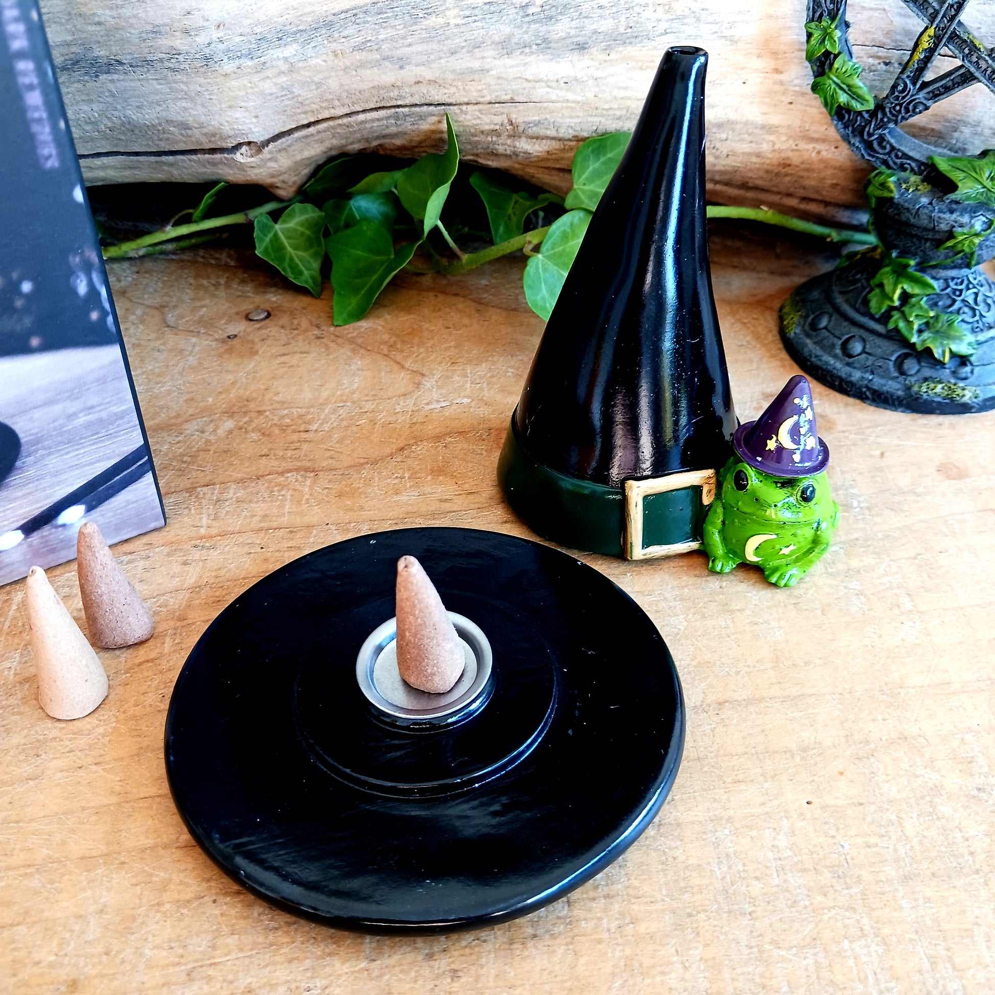 Add a touch of playful magic to your home with this charming Magic Toad & Witch Hat Incense Cone Holder. Made from resin, this quirky incense burner features a classic witch’s hat accompanied by a cute toad, creating a fun and mystical piece of witchy home décor.