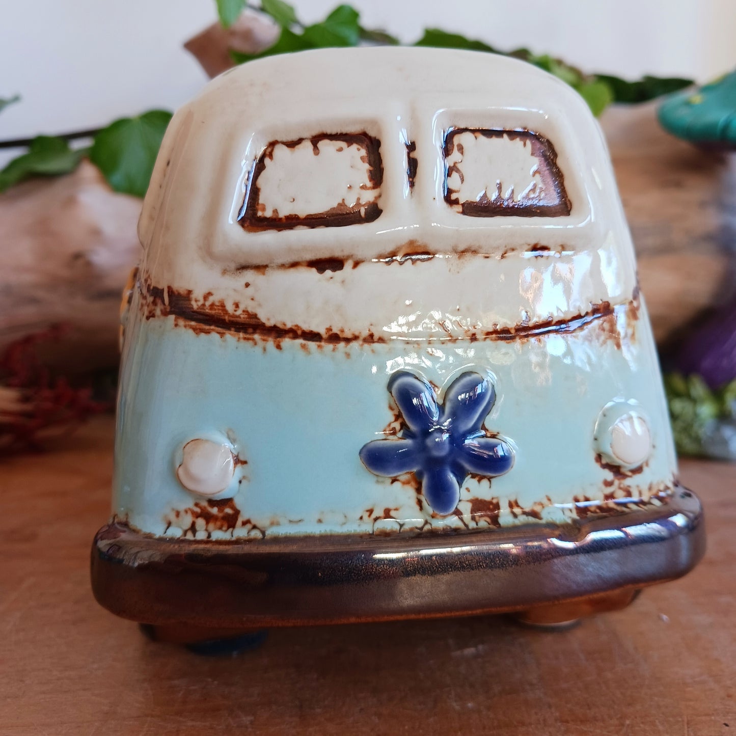 From the enchanted lanes of Village Pottery comes this Aqua VW Campervan Money Box, a charming ceramic treasure crafted for dreamers and wanderers alike. Measuring 11 x 18.5 x 10cm, this delightful piece captures the spirit of adventure with its soft aqua glaze, vintage VW Campervan design, and hand-painted detailing that feels kissed by fairy dust.