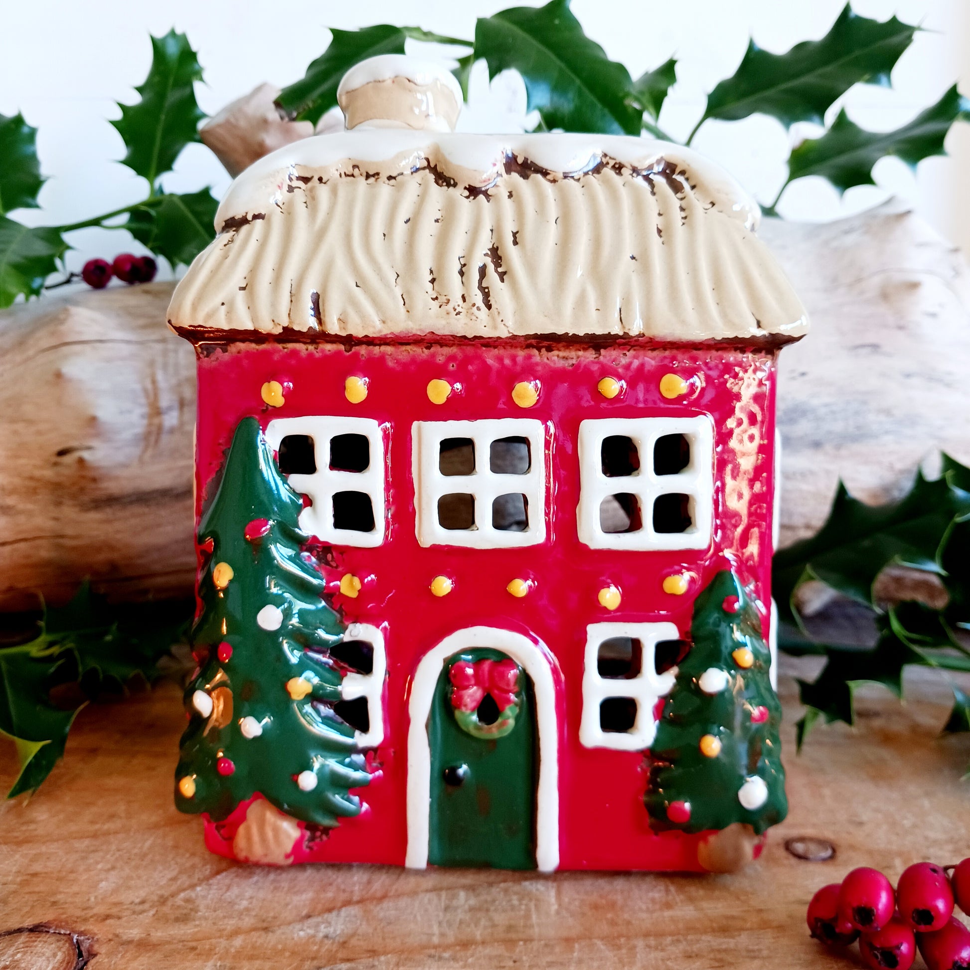 Bring timeless festive charm into your home with the Village Pottery Christmas Thatched Roof House Tealight Holder, a handcrafted ceramic cottage glowing with the spirit of the season. Measuring 17 x 12.5 x 8.5 cm, this enchanting piece captures the essence of a peaceful winter’s night — where golden candlelight flickers through snowy windows beneath a soft thatched roof.
