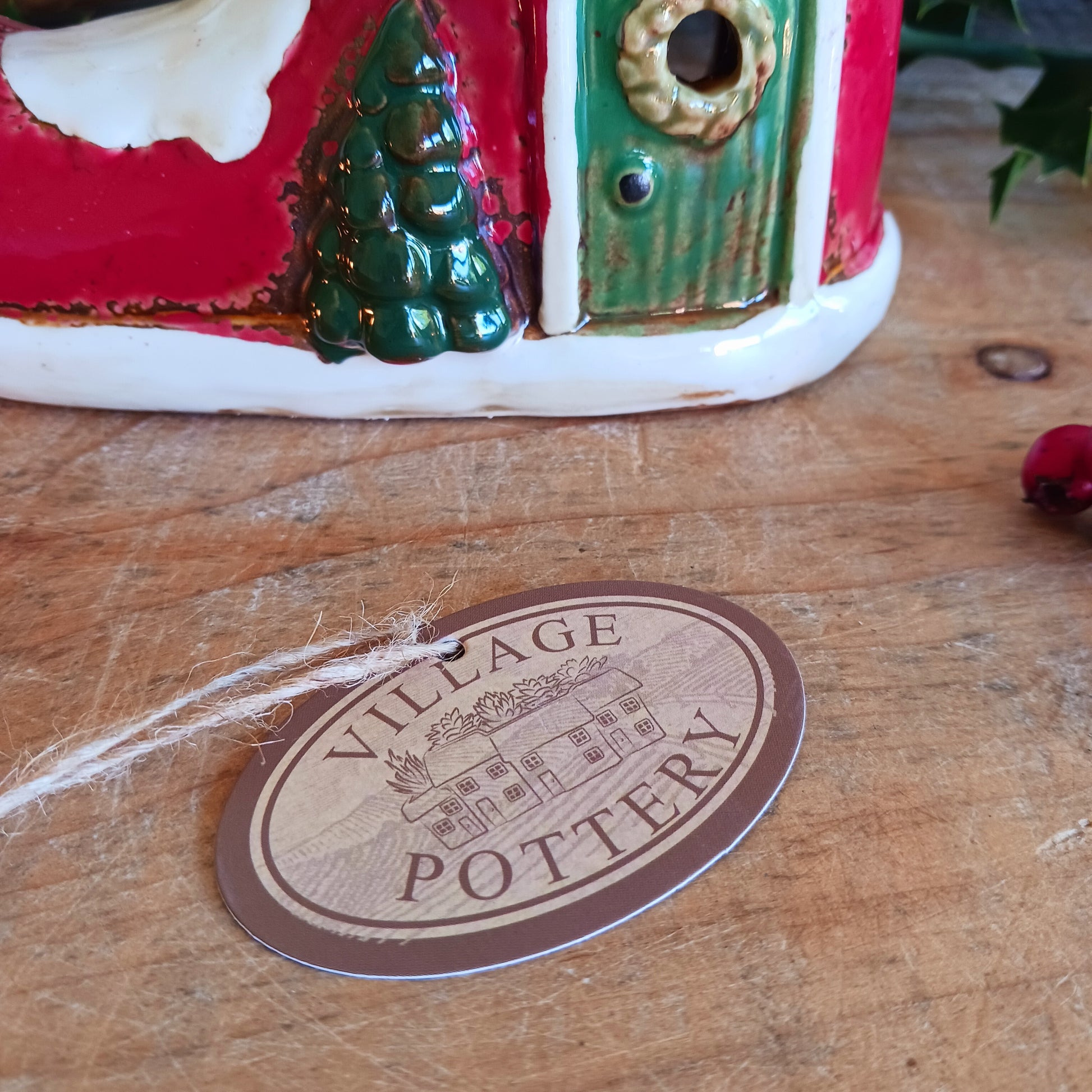 Step into the world of festive enchantment with the Village Pottery Christmas Elf Boot House Tealight Holder, a playful handcrafted ceramic creation bursting with Christmas spirit. Measuring 16 x 16 x 9.5 cm, this delightful piece takes the shape of a cheerful elf’s boot turned into a cosy little house, complete with twinkling windows and snowy details.